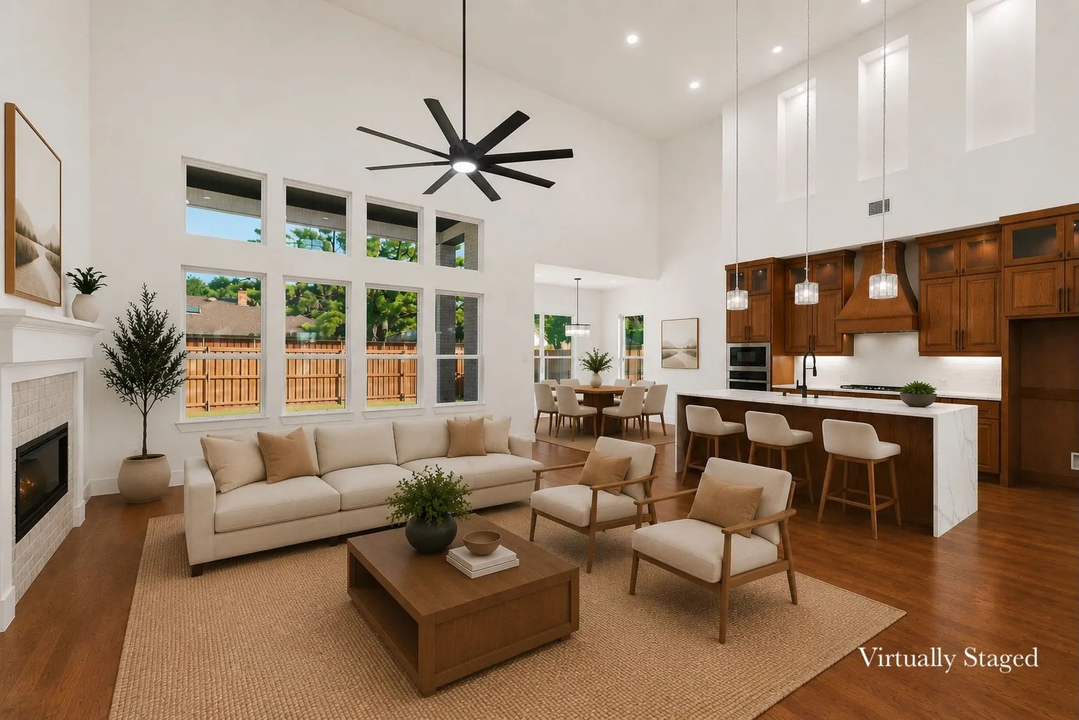 Vaulted ceilings frame the open-concept living space, featuring a fireplace with tile surround, a wall of windows, and rich wood-finish flooring