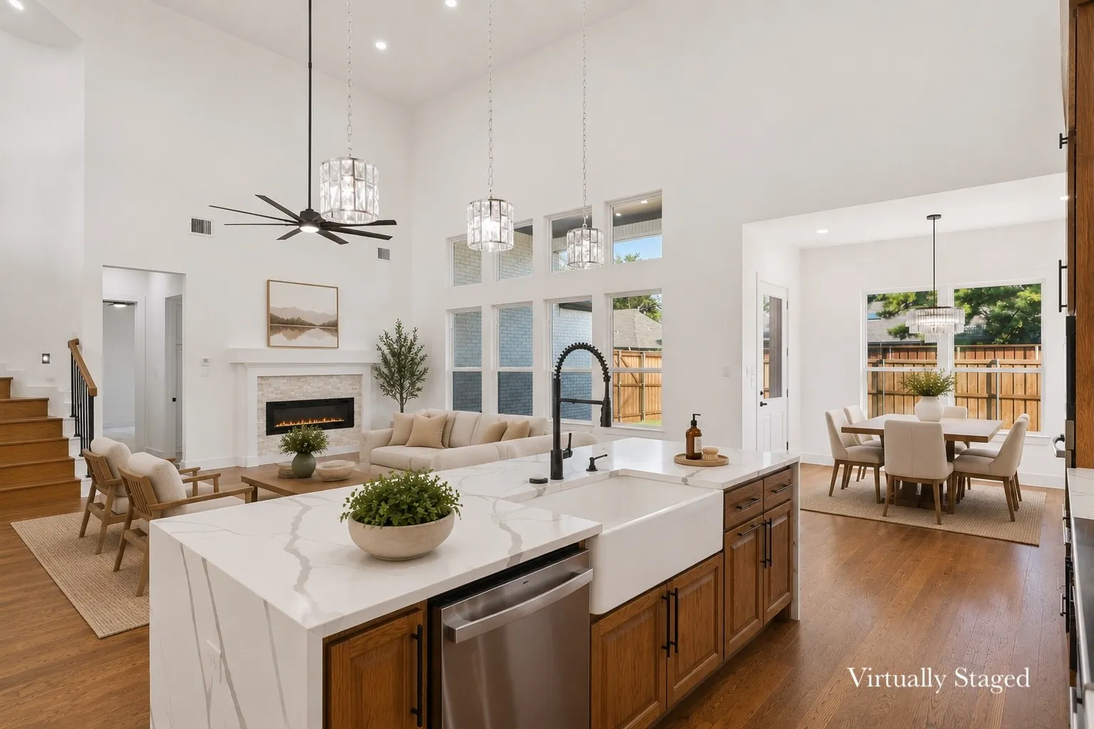 Kitchen island with waterfall quartz countertop, farmhouse sink, and integrated dishwasher
