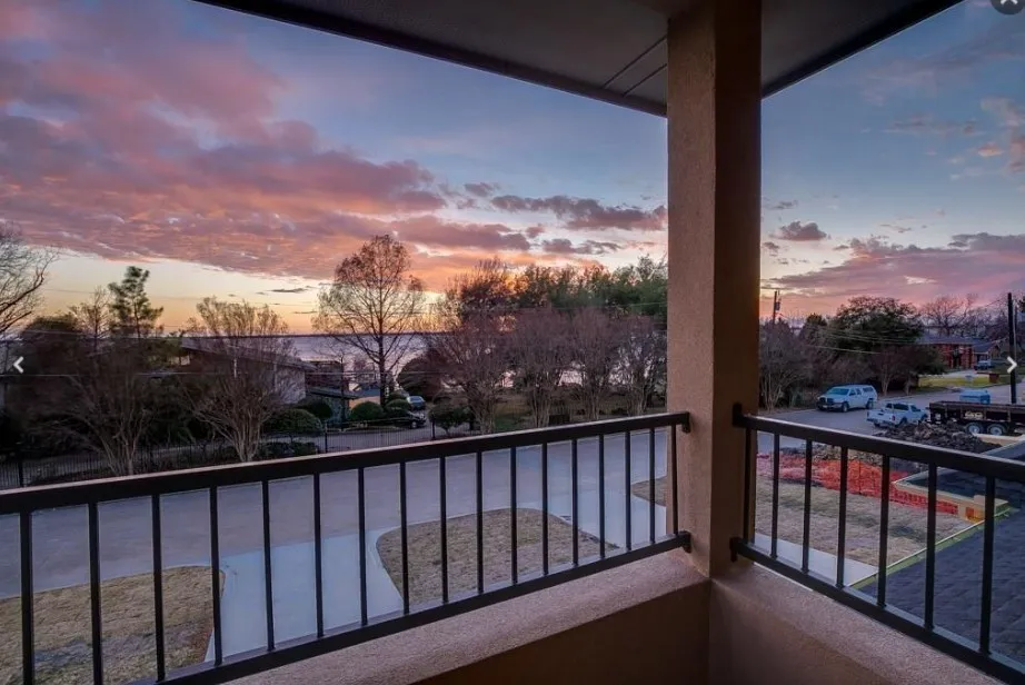 Balcony featuring a black metal railing and a stucco exterior finish