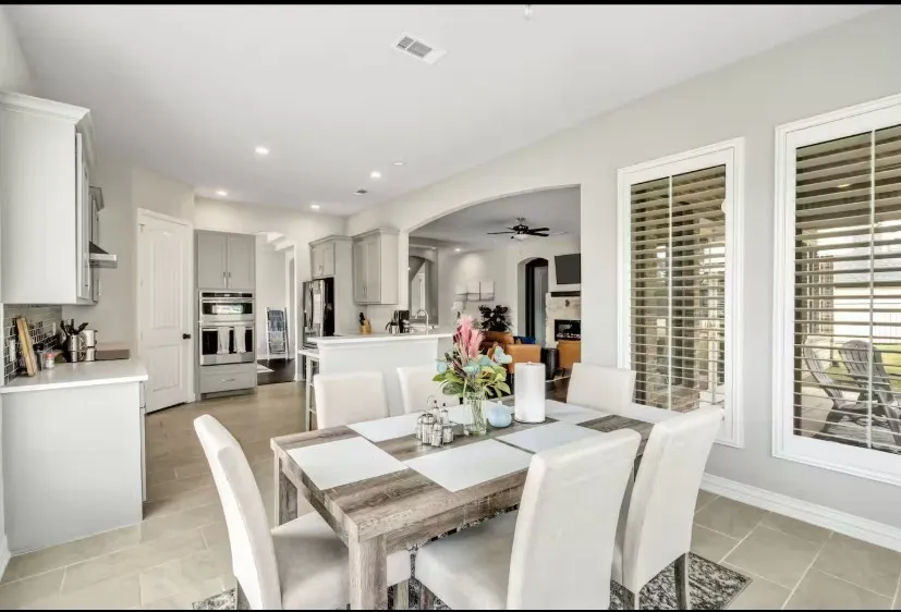 Dining area with tile flooring and abundant natural light from multiple windows