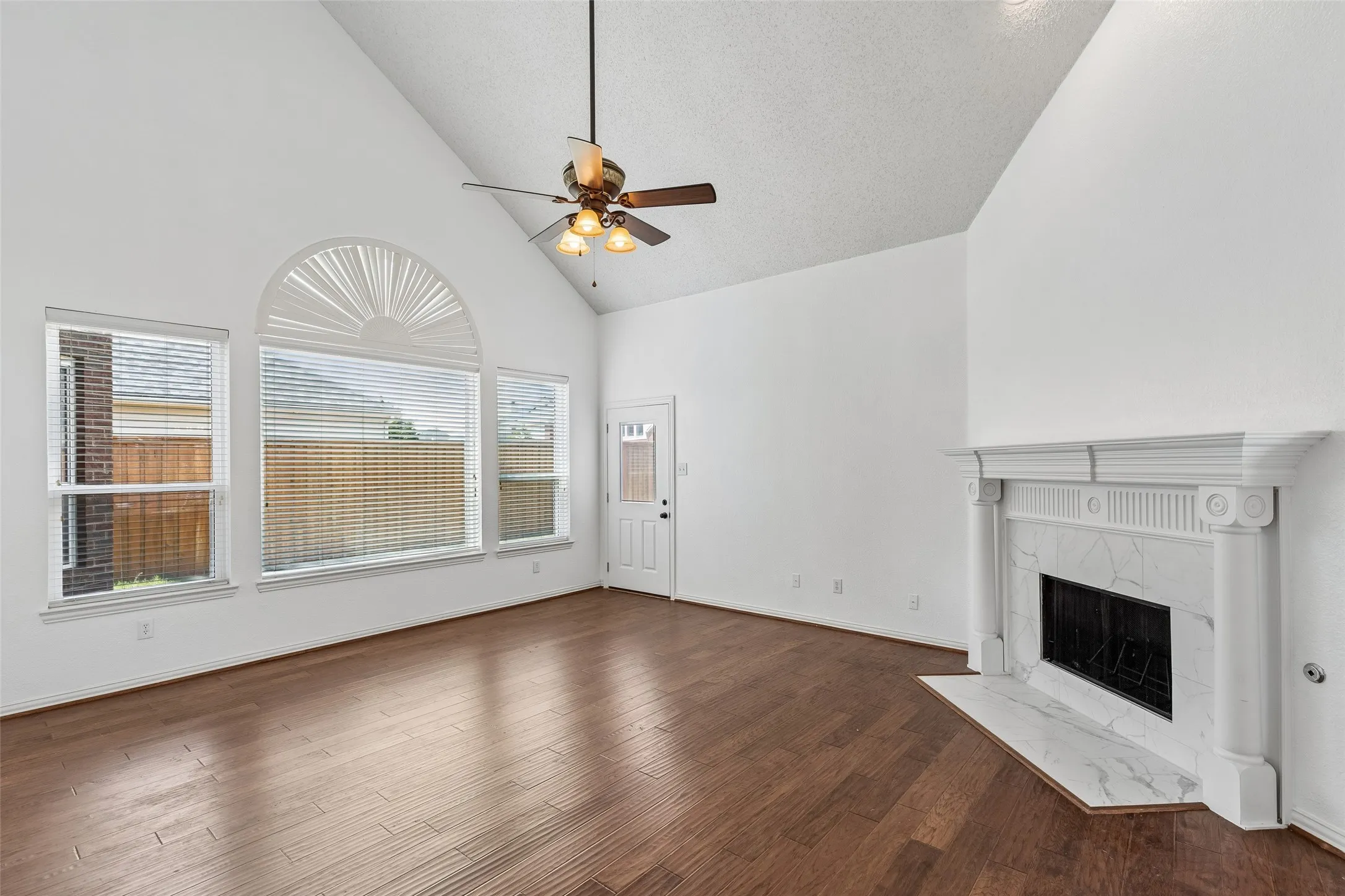 High vaulted ceiling with lots of great light flowing through and attractive fireplace with gas starter.