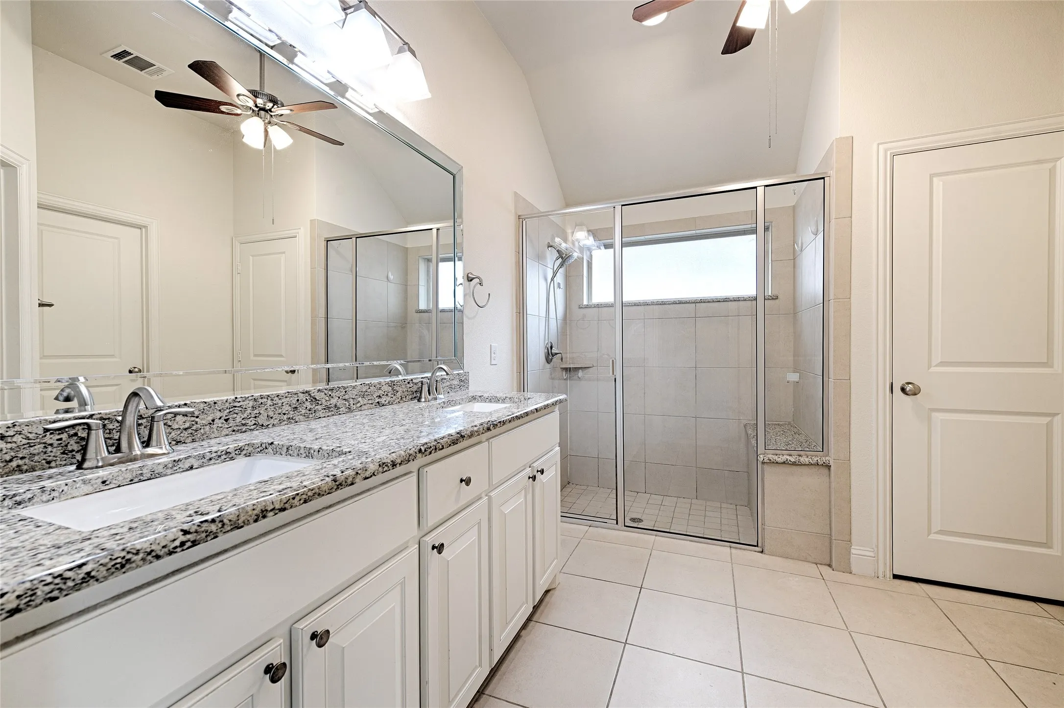 Double vanity with granite countertops, undermount sinks, and chrome fixtures