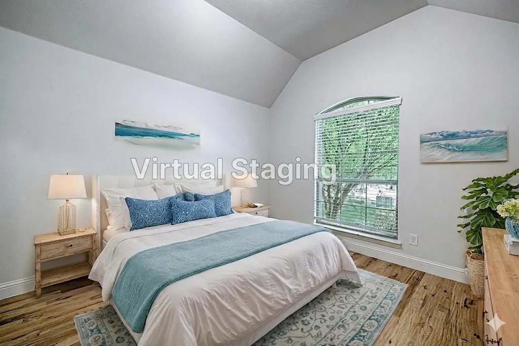 Vaulted ceiling bedroom featuring wood-finish flooring, an arched window with blinds, and white wall finishes