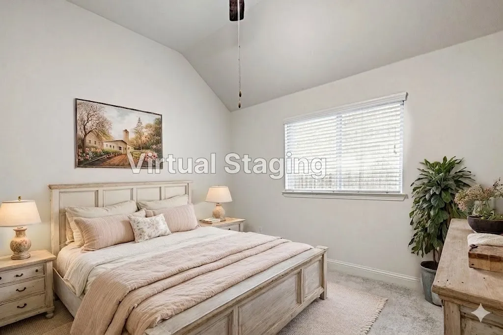 Bedroom featuring a vaulted ceiling and neutral wall tones
