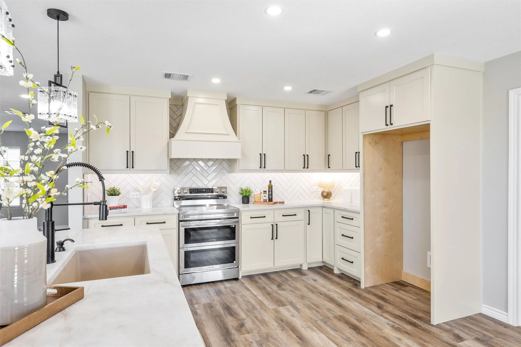 High end stainless appliances including a convection double over and air fryer.
