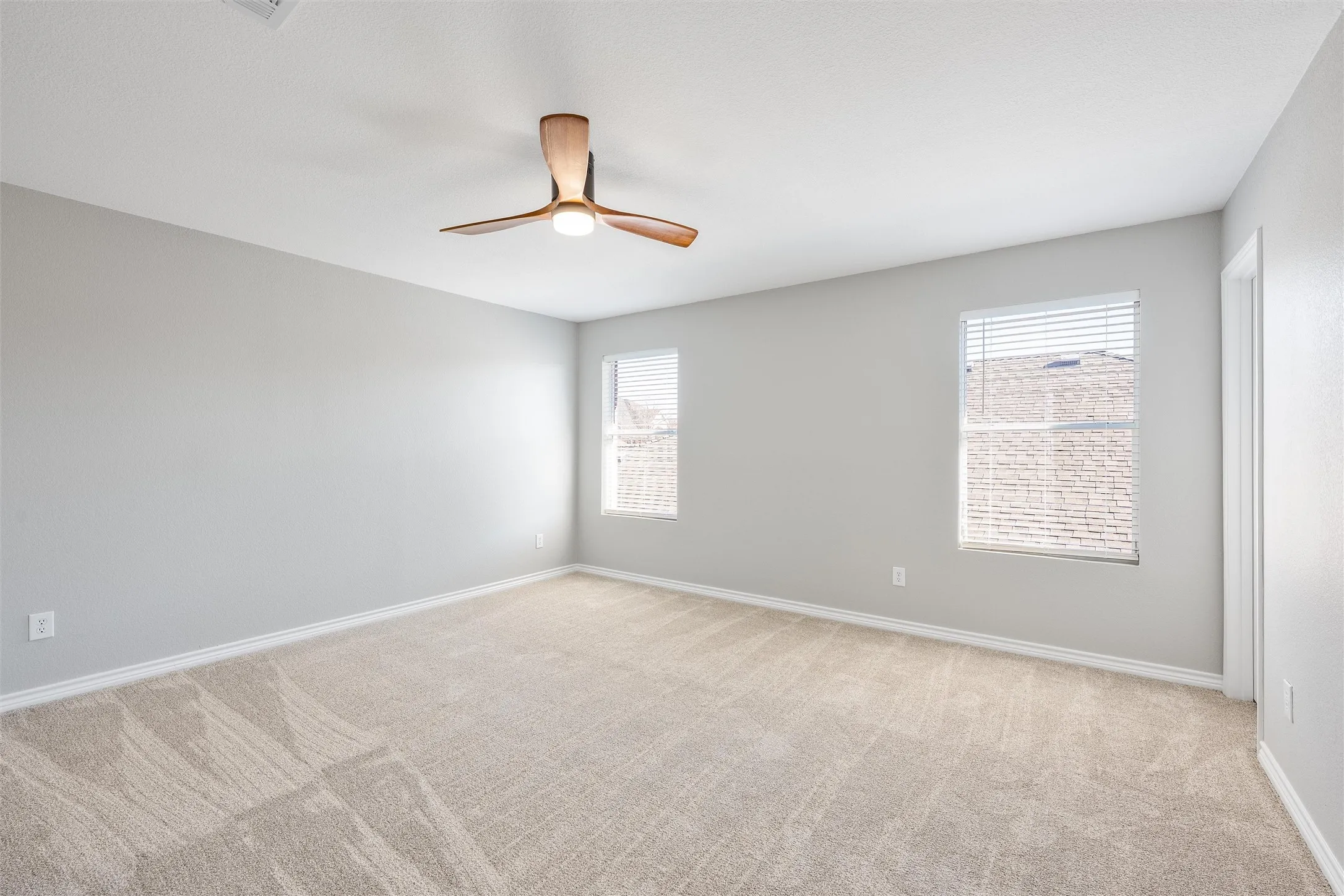 Upstairs bedroom #3 with walk in closet, new carpet and ceiling fan