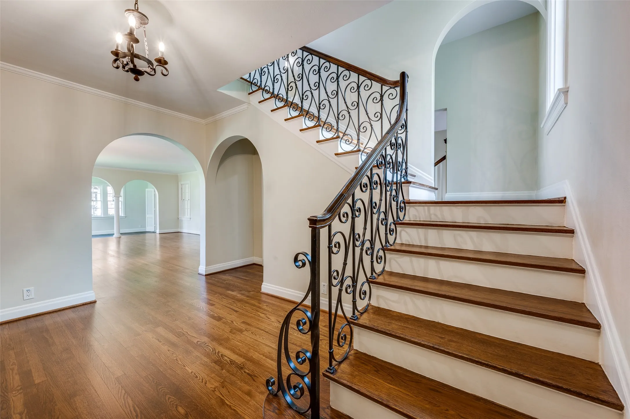 Elegant split staircase leading upstairs from the welcoming foyer.