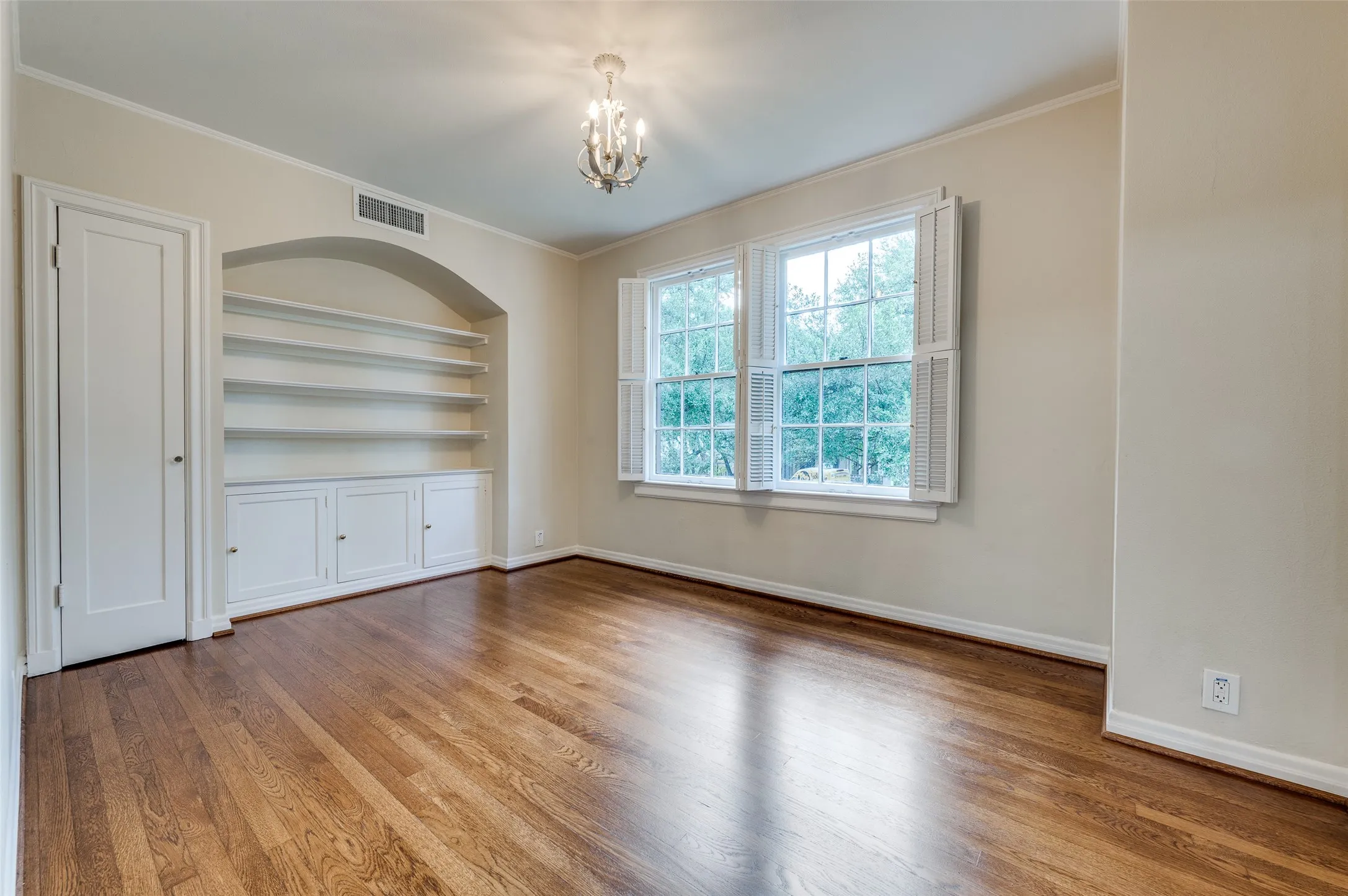 Second floor flex room with built-in cabinets and shelves.