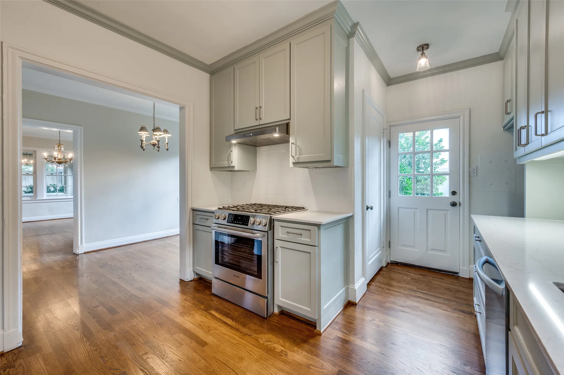 Just renovated kitchen with quartz countertops, stainless steel appliances and sage colored cabinetry.