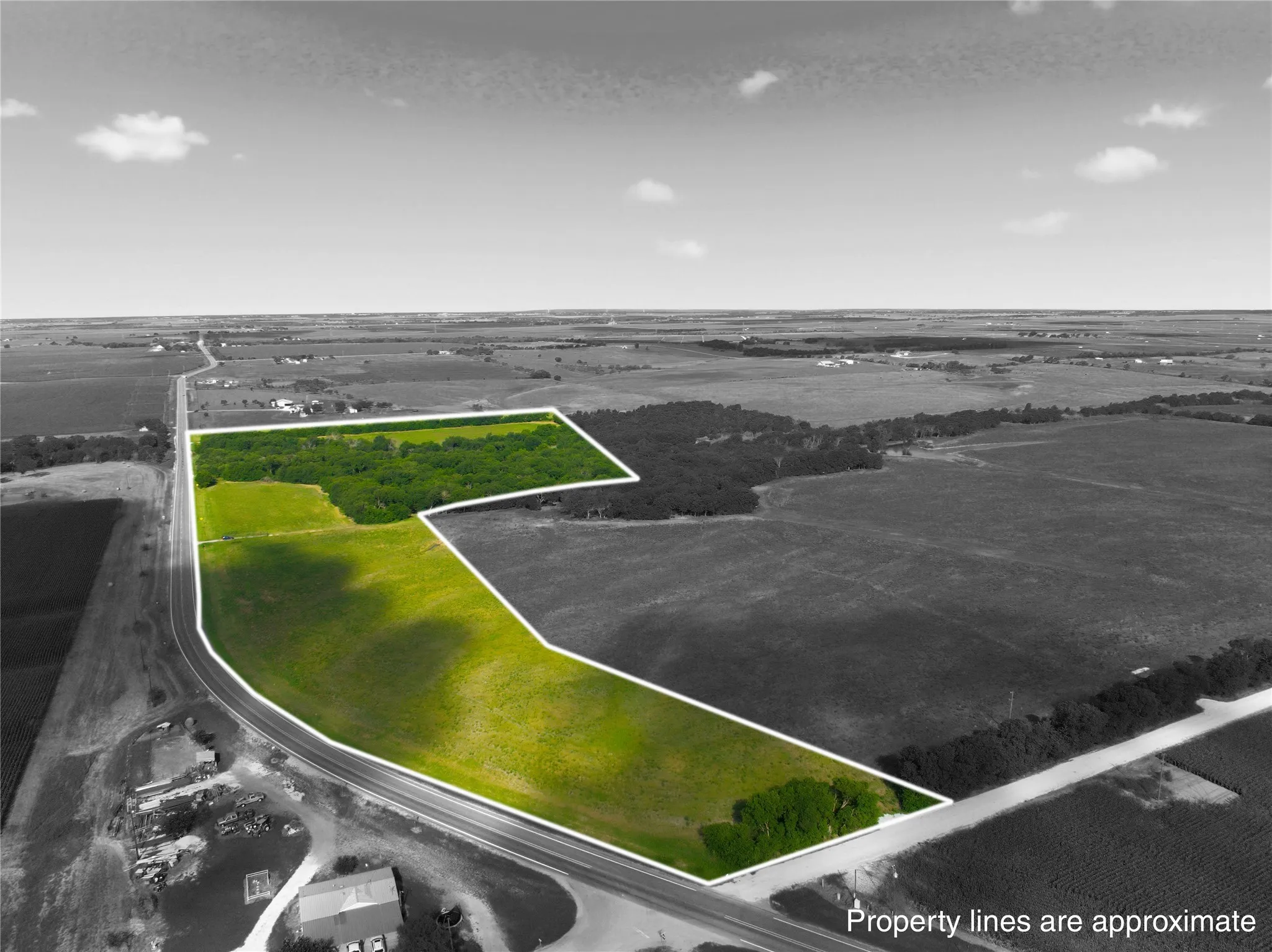 Expansive parcel featuring open fields and mature tree coverage