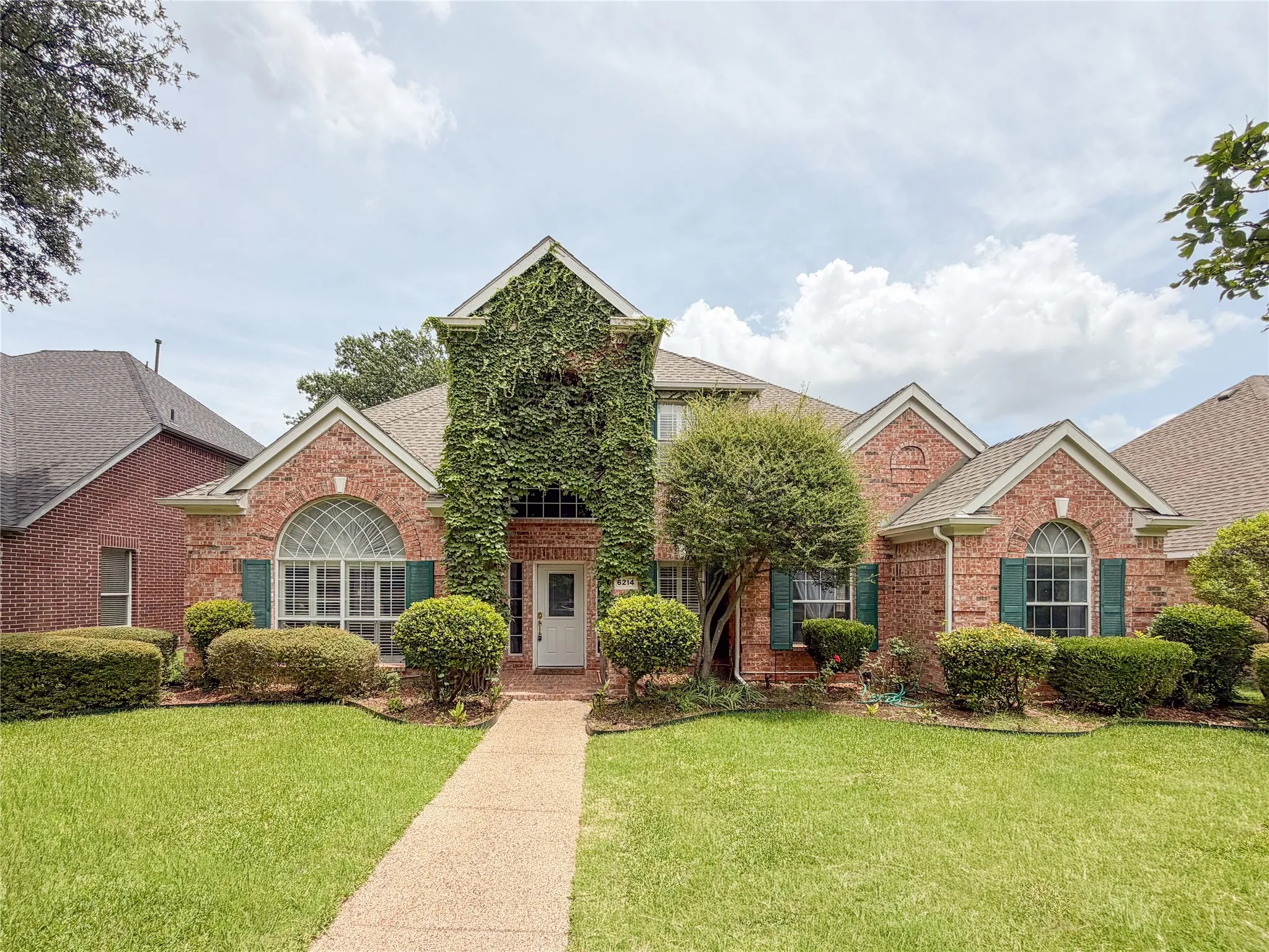 Brick exterior with architectural gables and green shutters