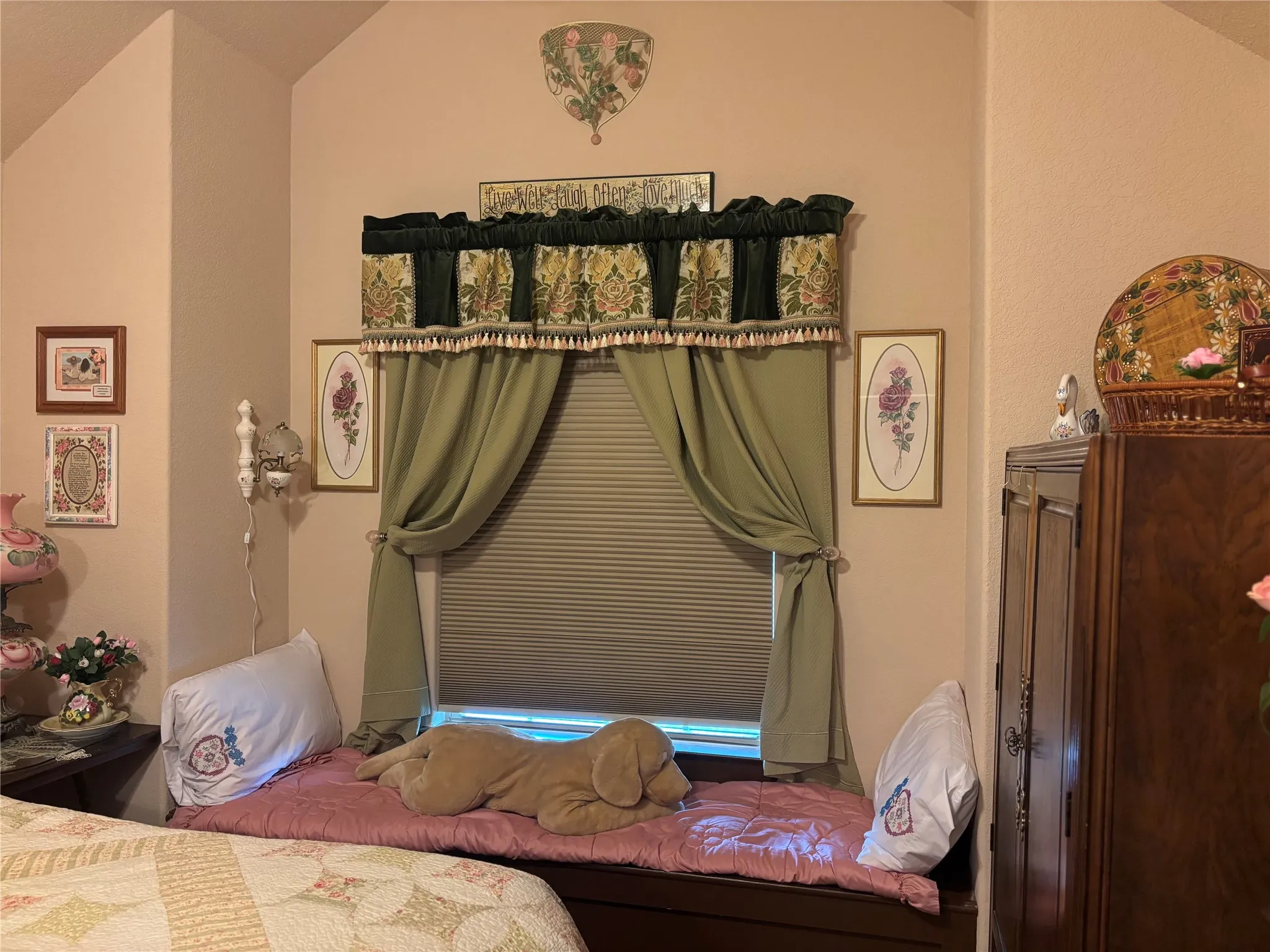 Window seating with a built-in storage bench, complemented by a valance and drapes