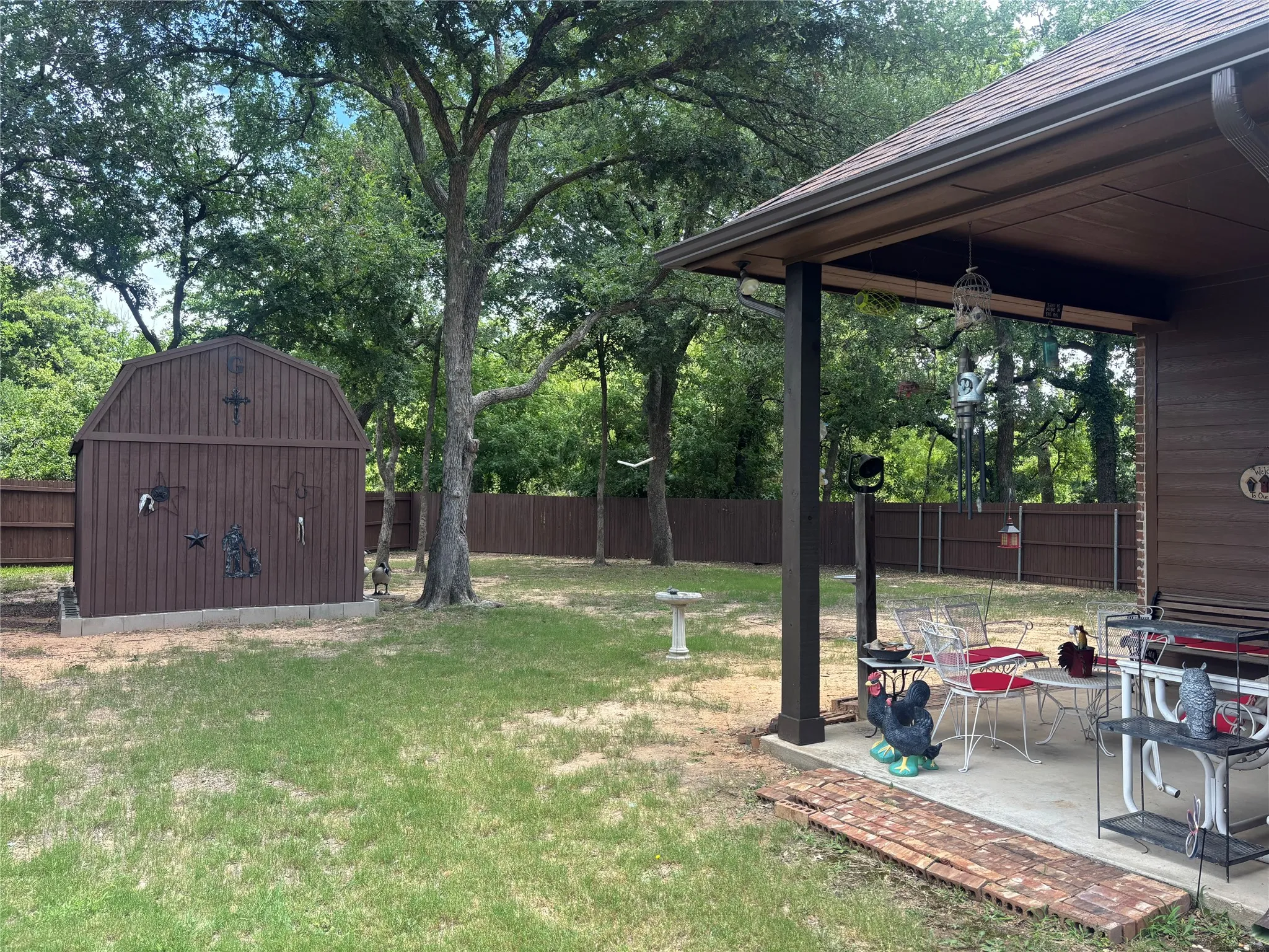 Covered patio, wooded lot, large shed