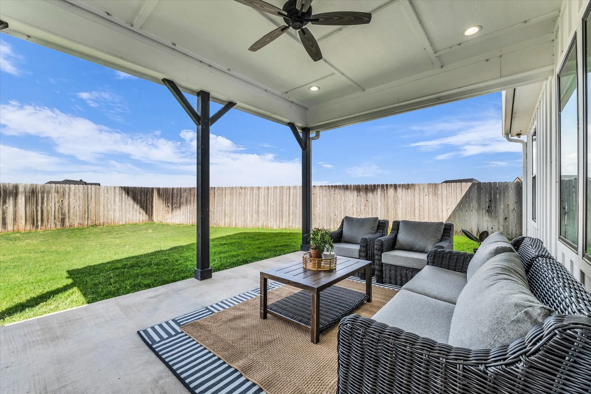blue sky views while shaded by the covered porch with ceiling fan