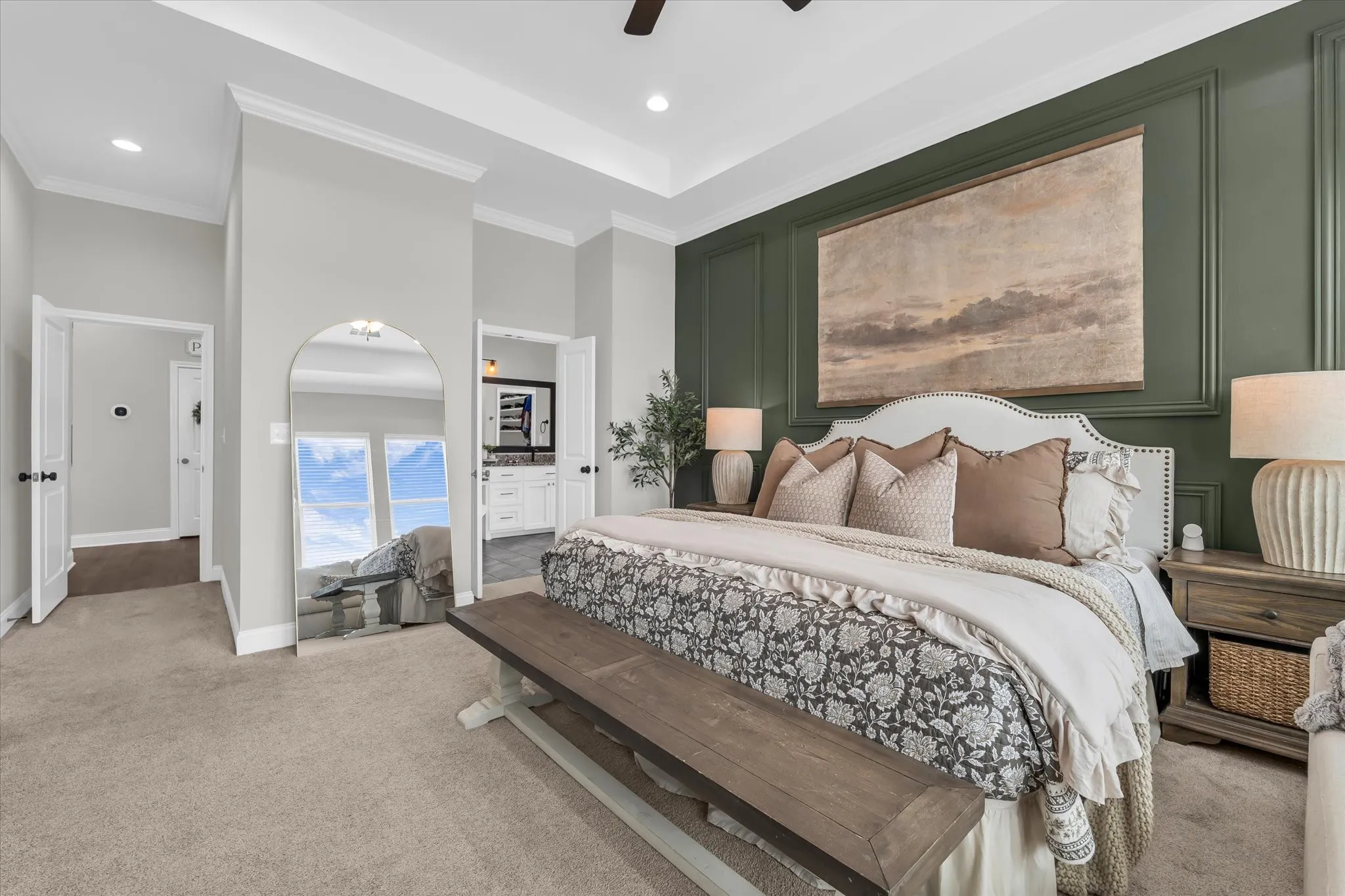 isolated primary bedroom with accent wall and ensuite bathroom