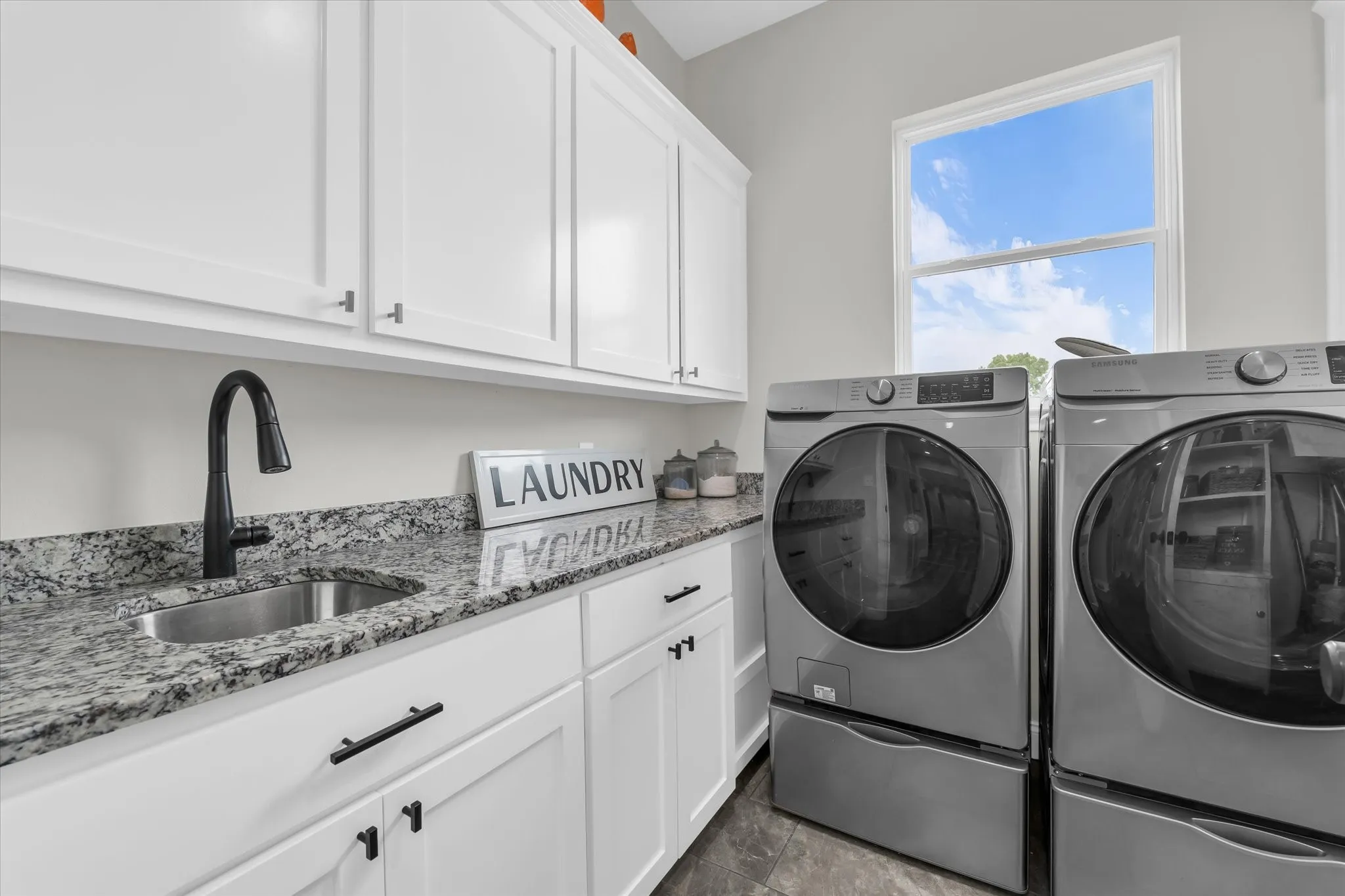 sink and ample storage in separate laundry room