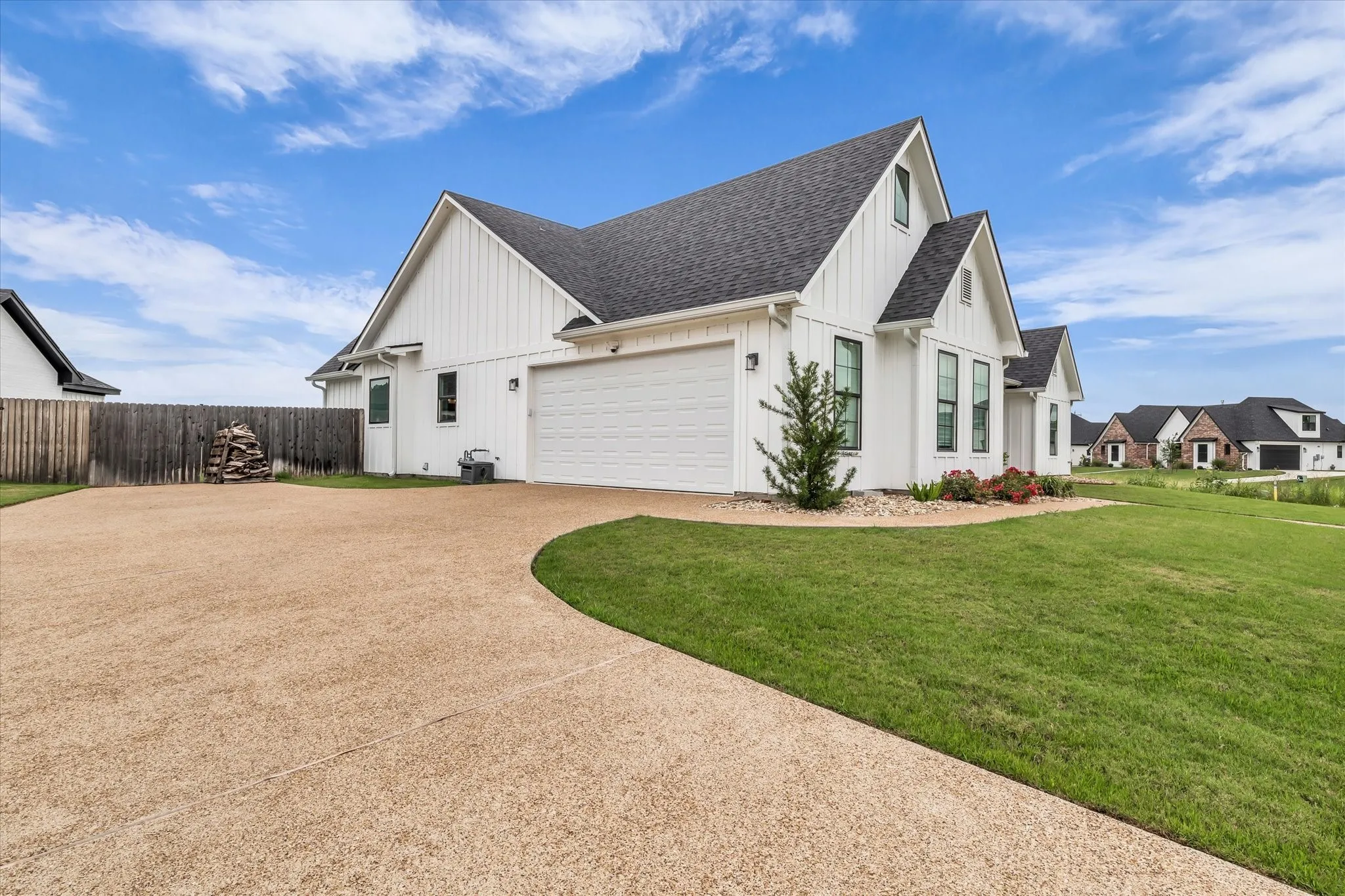 side entry garage with 2+ car capacity and abundant driveway parking