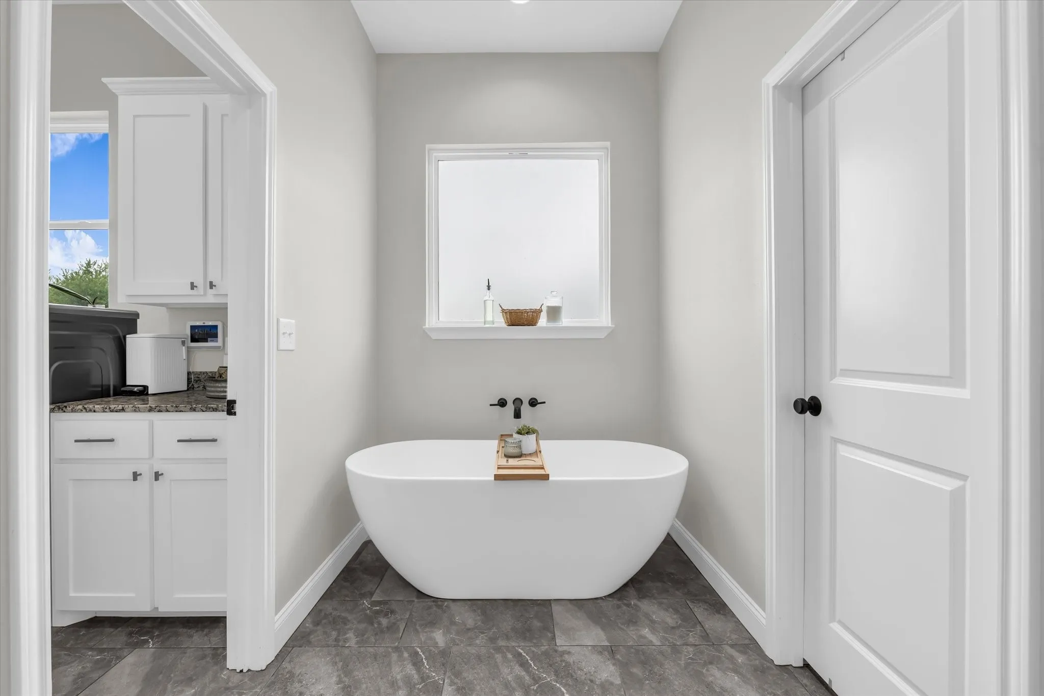 soaking tub in primary ensuite bathroom