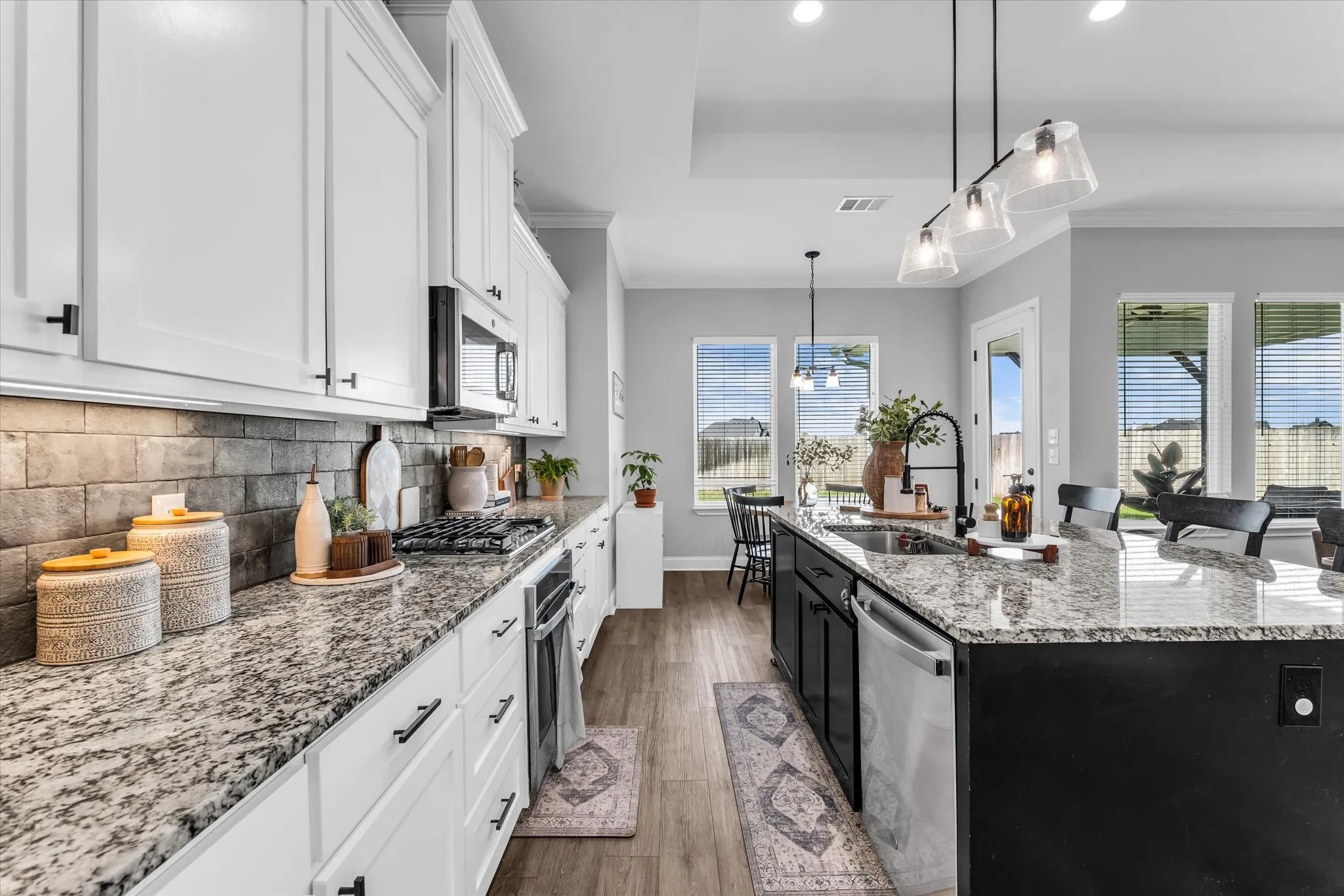 large island with sink and plenty of countertop workspace to host and entertain