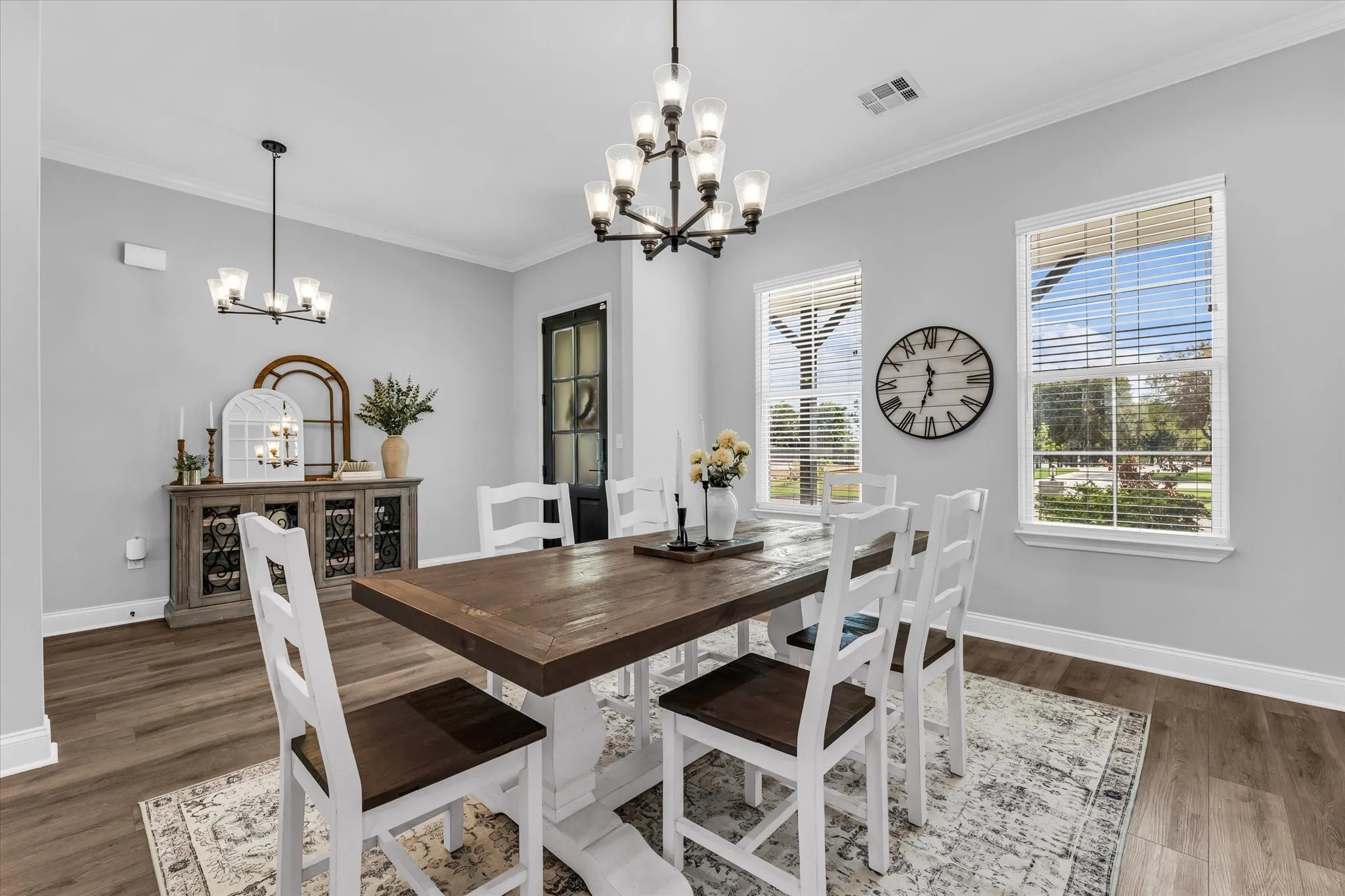 dining room with large windows and open layout to entry way
