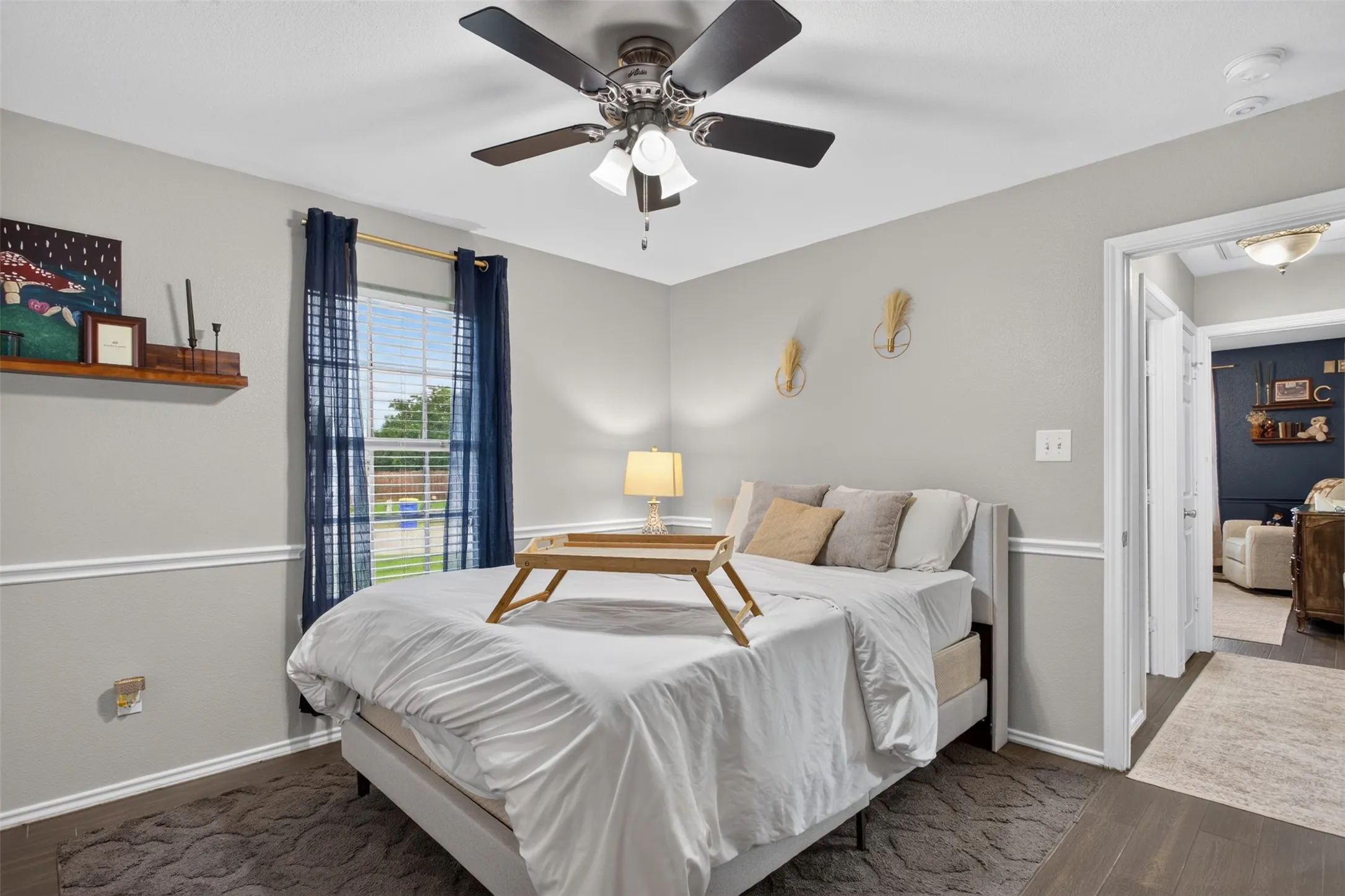 Room featuring dark wood-finish flooring, light gray wall paint, and white crown molding