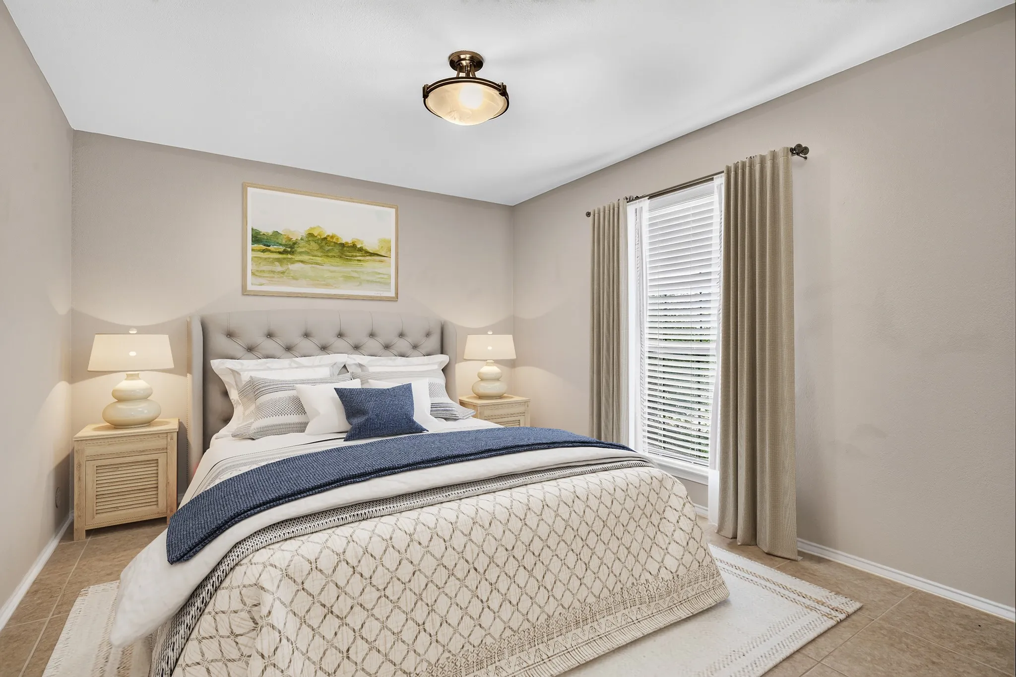 Two additional beds share an updated bath with granite countertops, white cabinetry & a seamless glass shower. The furniture and decor in this photo has been virtually staged, not altering the room.