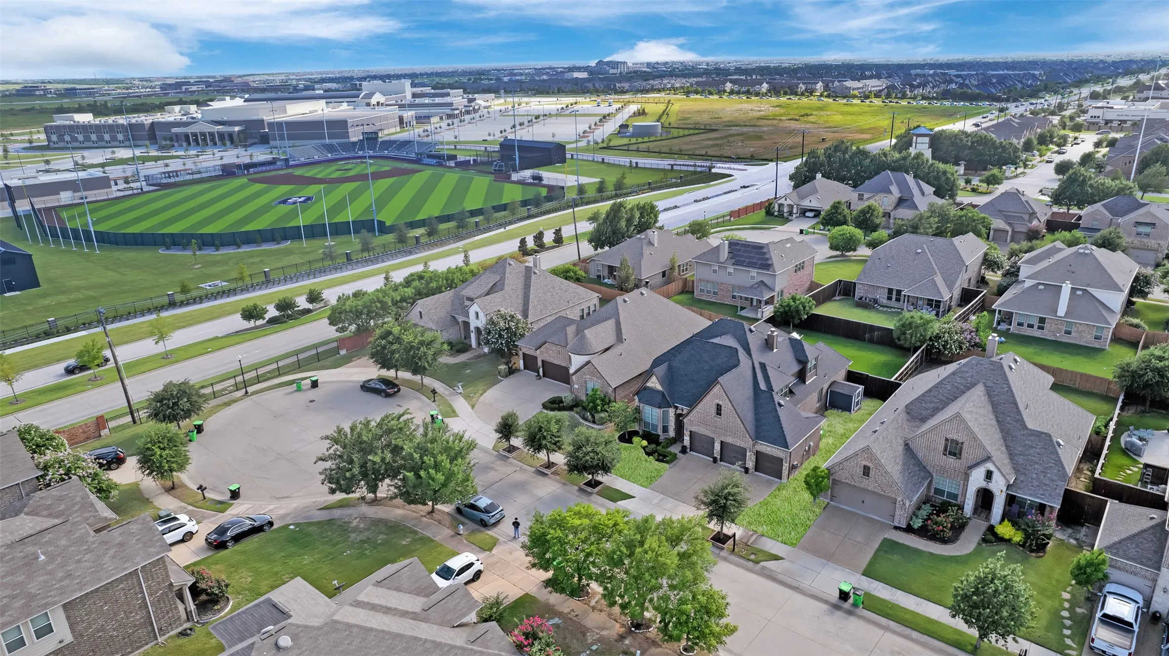 Aerial perspective highlighting a residential neighborhood with a prominent baseball field nearby