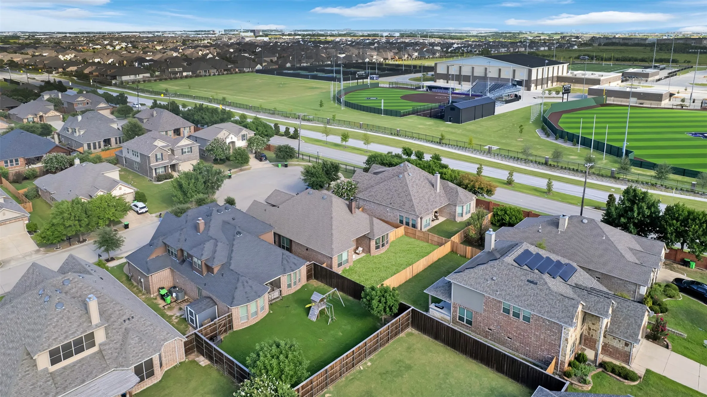 Residential neighborhood featuring a variety of single-family homes with pitched roofs and fenced backyards