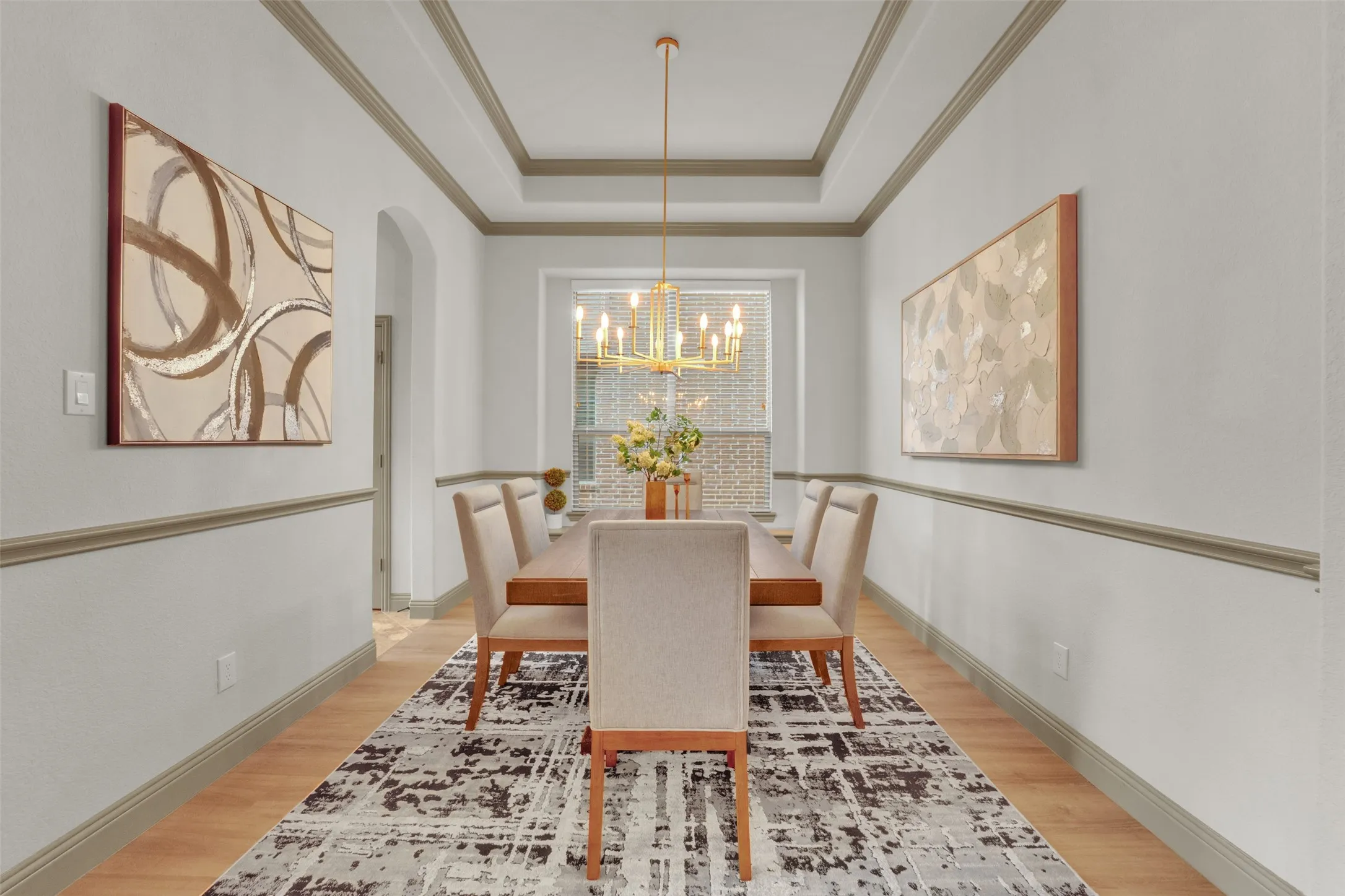 Formal dining area featuring wood-finish flooring and a tray ceiling