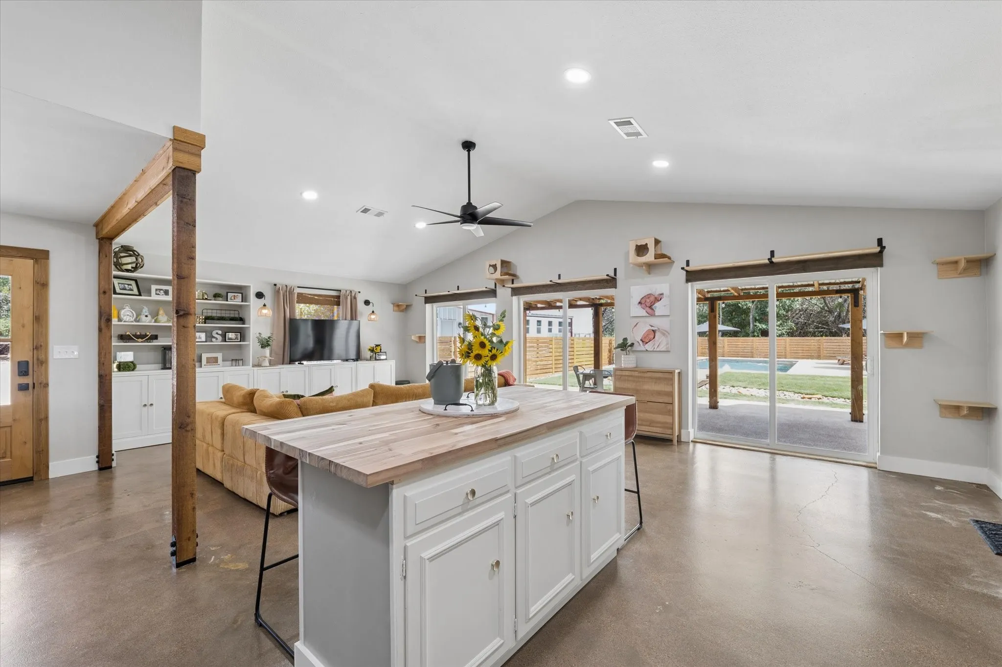 Kitchen island with a wood-finish countertop and white cabinetry