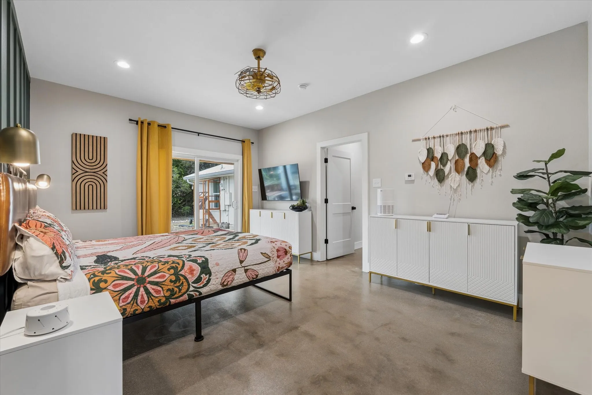 Spacious room featuring concrete-finish flooring, recessed lighting, and a ceiling fan