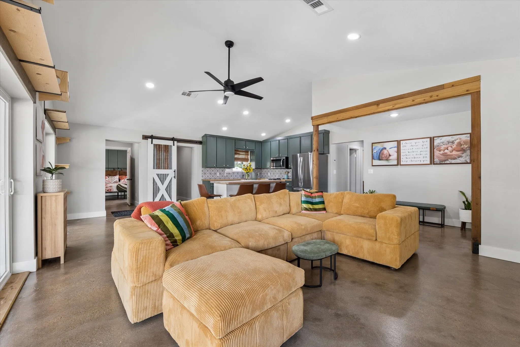 Open-concept living space featuring wood-finish flooring, recessed lighting, and a modern ceiling fan