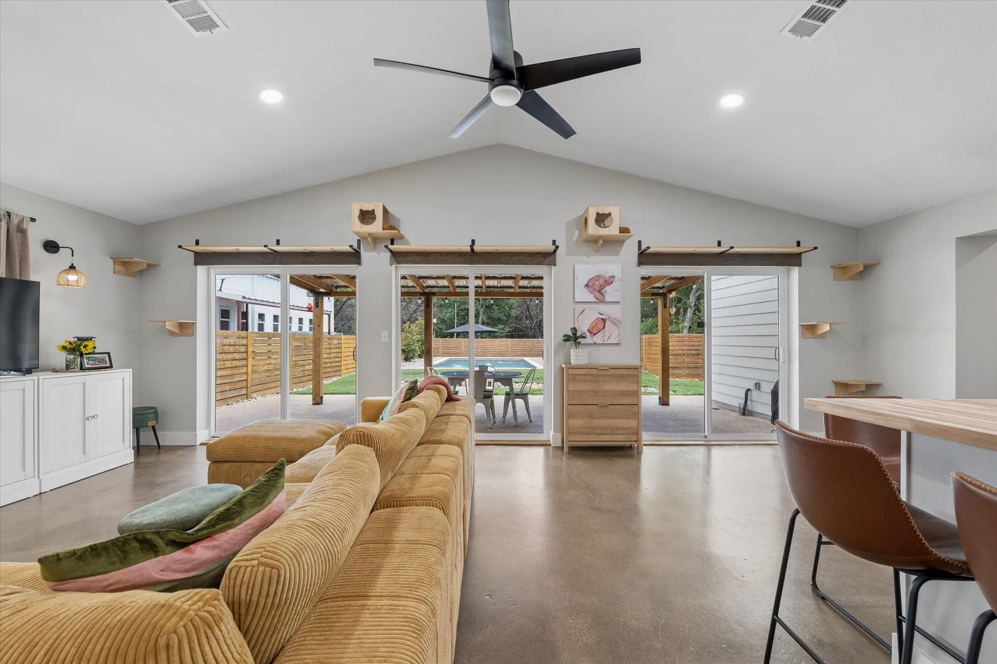 Vaulted ceilings with recessed lighting and a ceiling fan