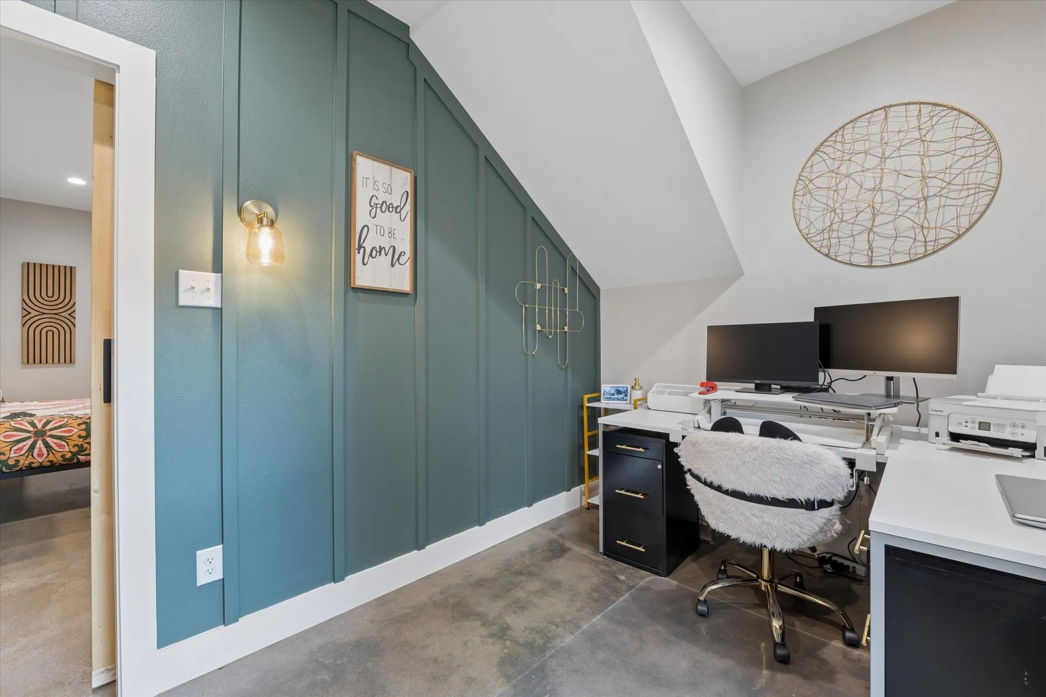 Dedicated workspace featuring a board and batten accent wall in a deep teal hue