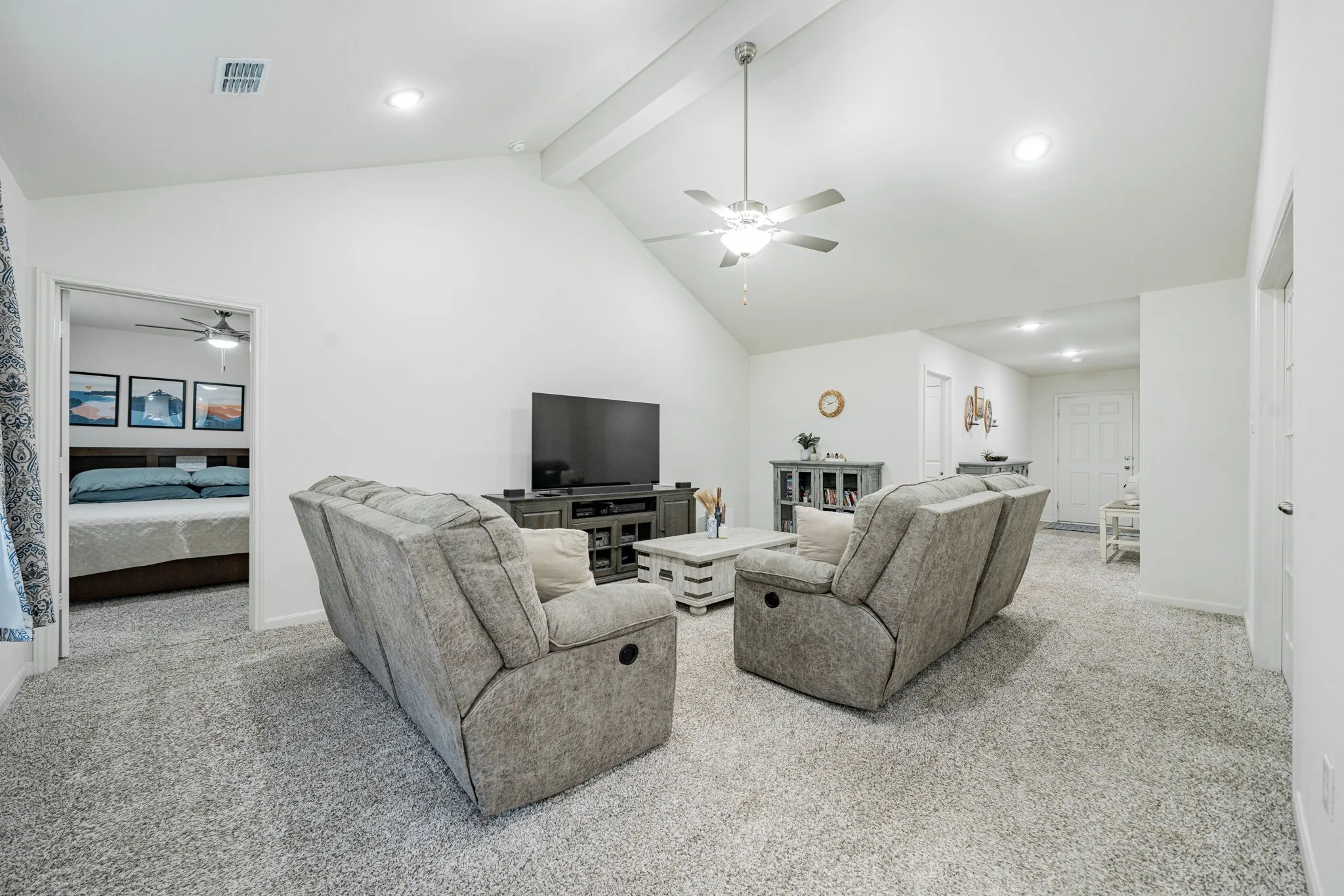 Vaulted ceiling living room featuring recessed lighting, a ceiling fan, plush carpet flooring, and white walls