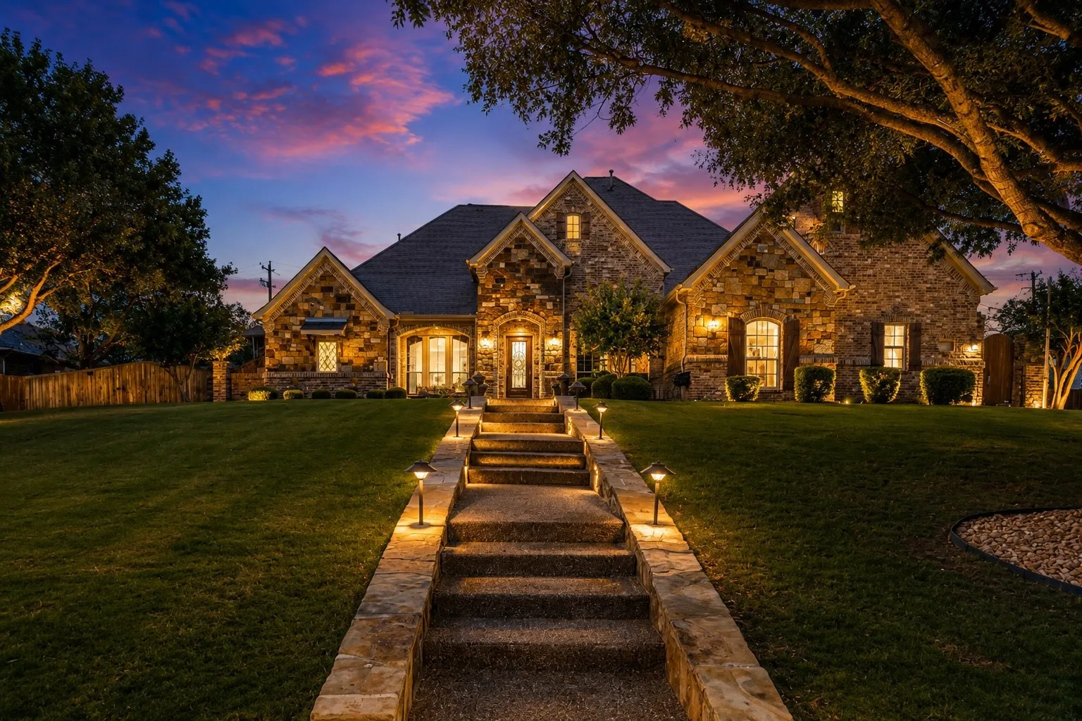 Stone facade residence featuring a multi-gabled roofline and an inviting stone pathway
