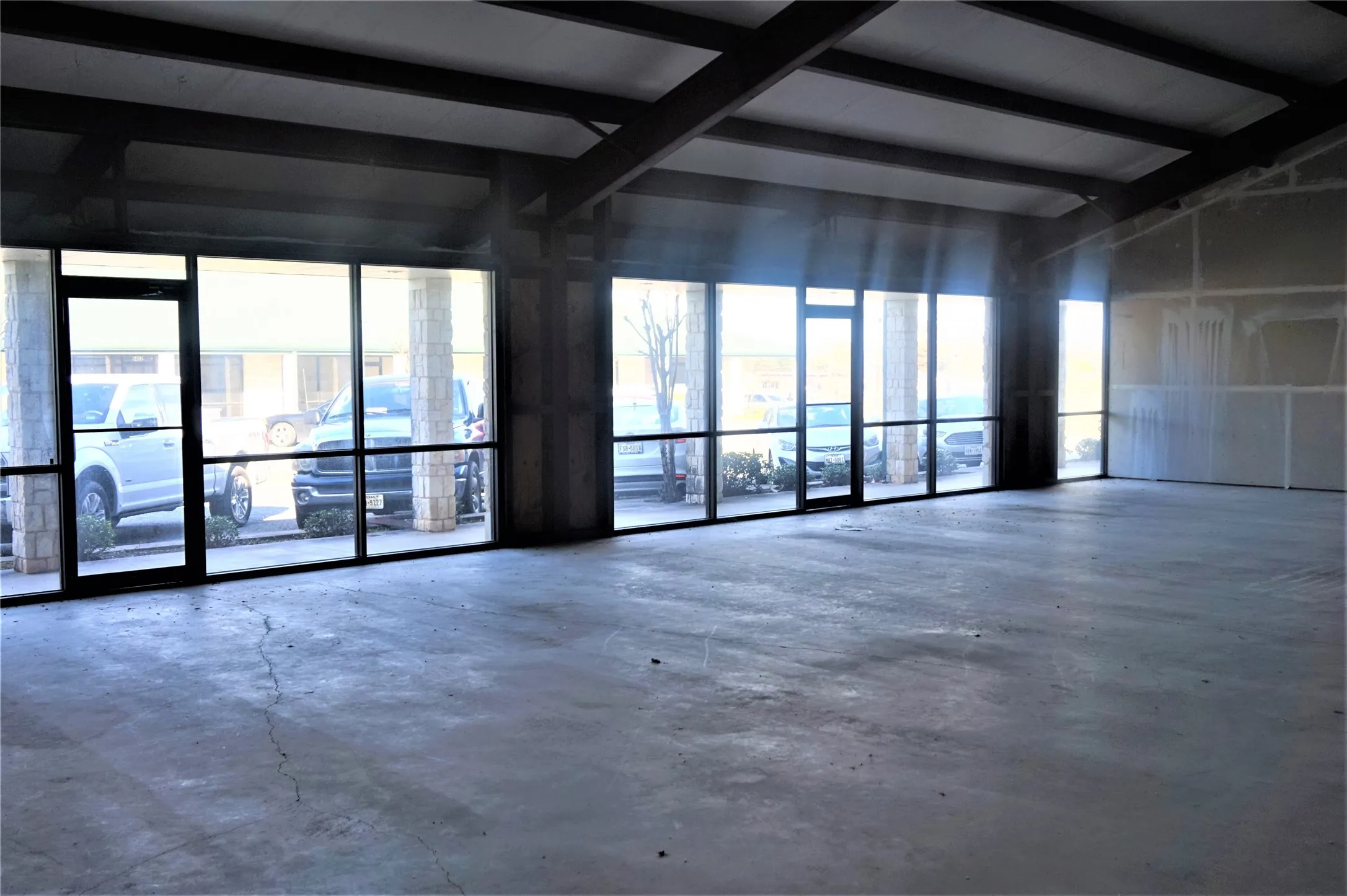 Unfurnished room featuring concrete flooring and plenty of natural light