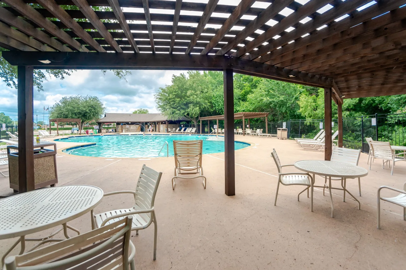 Expansive outdoor pool area featuring a large, irregularly shaped swimming pool