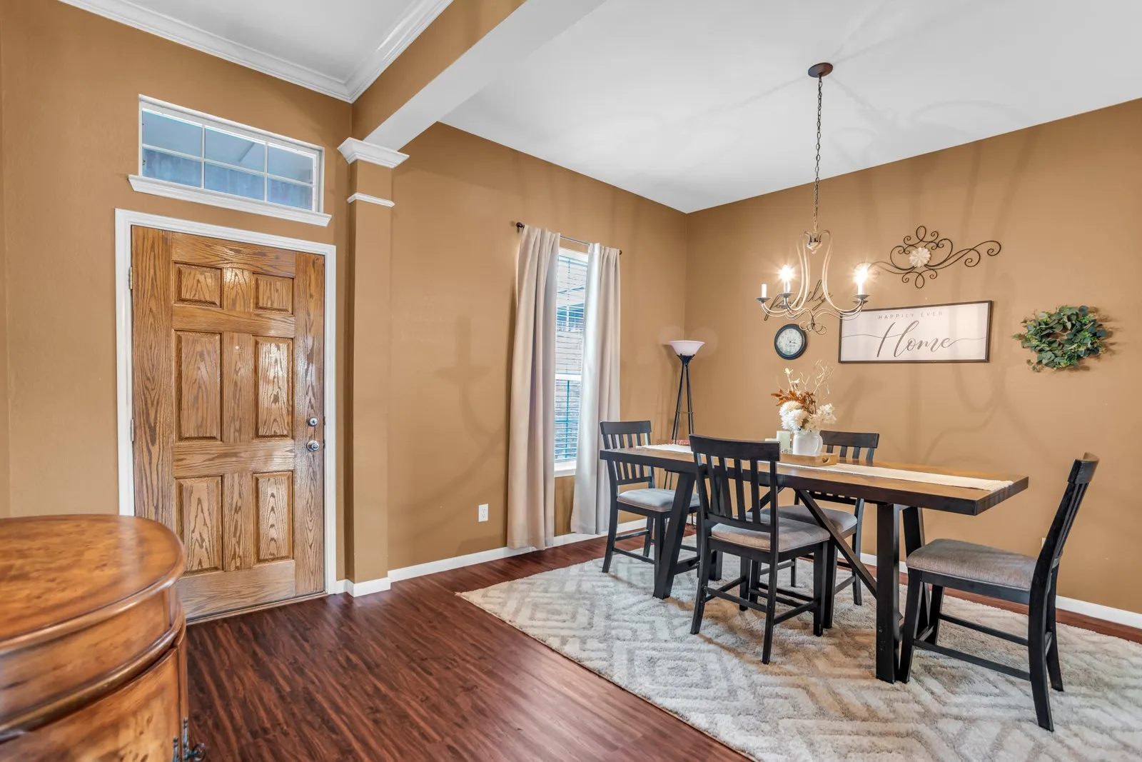 Paneled wood entry door with transom window