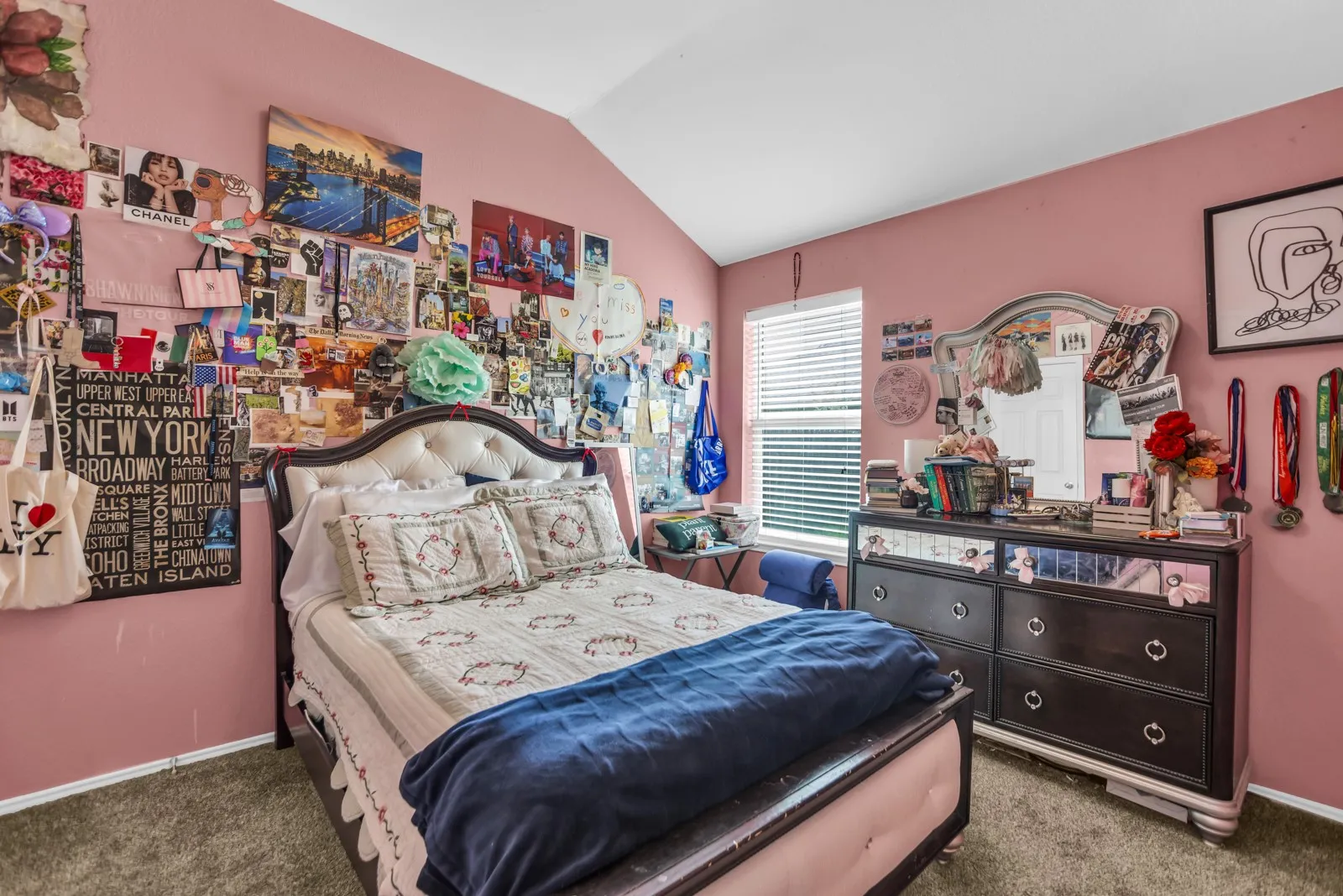 Room featuring vaulted ceilings, a window with blinds, and carpet flooring