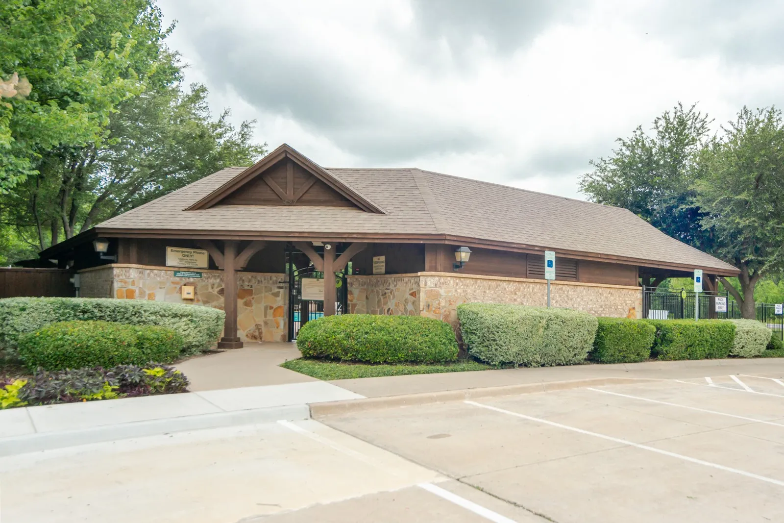 Community pavilion building featuring stone veneer and wood siding