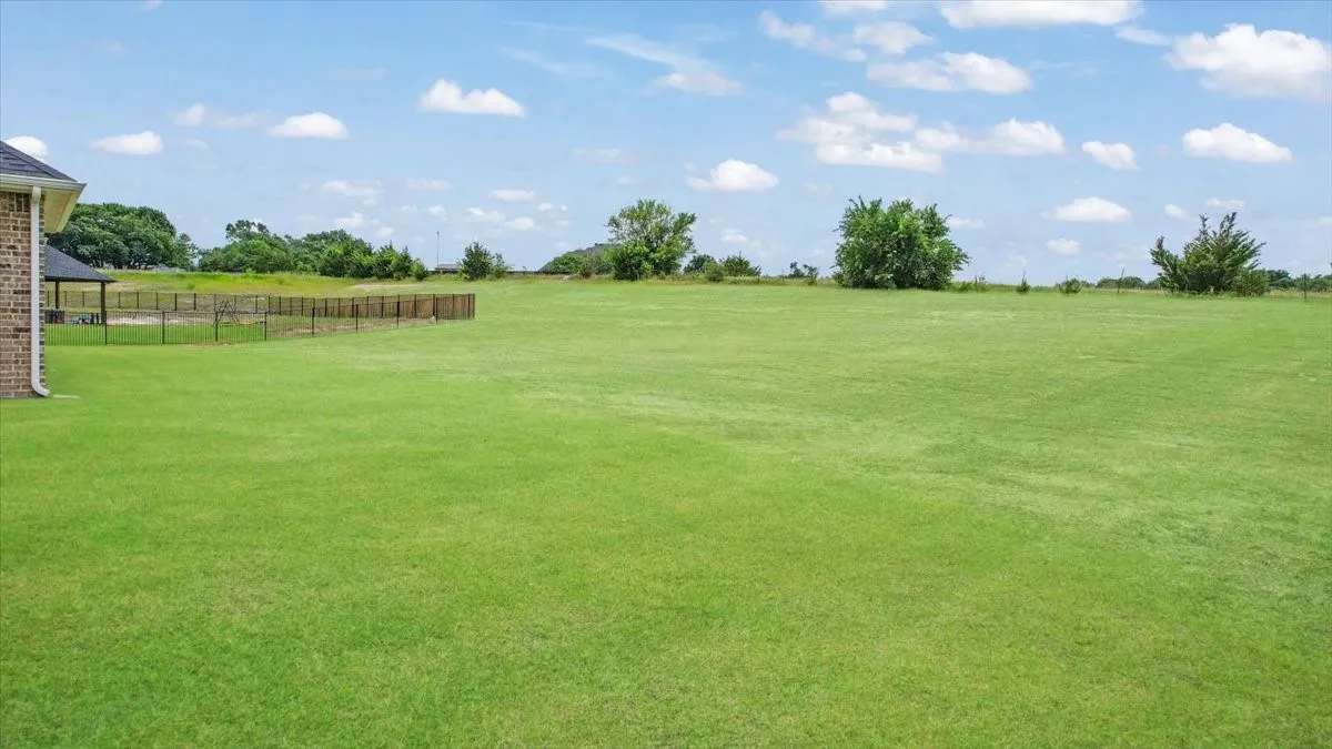 Backyard facing SE. There is a large ranch behind this property.