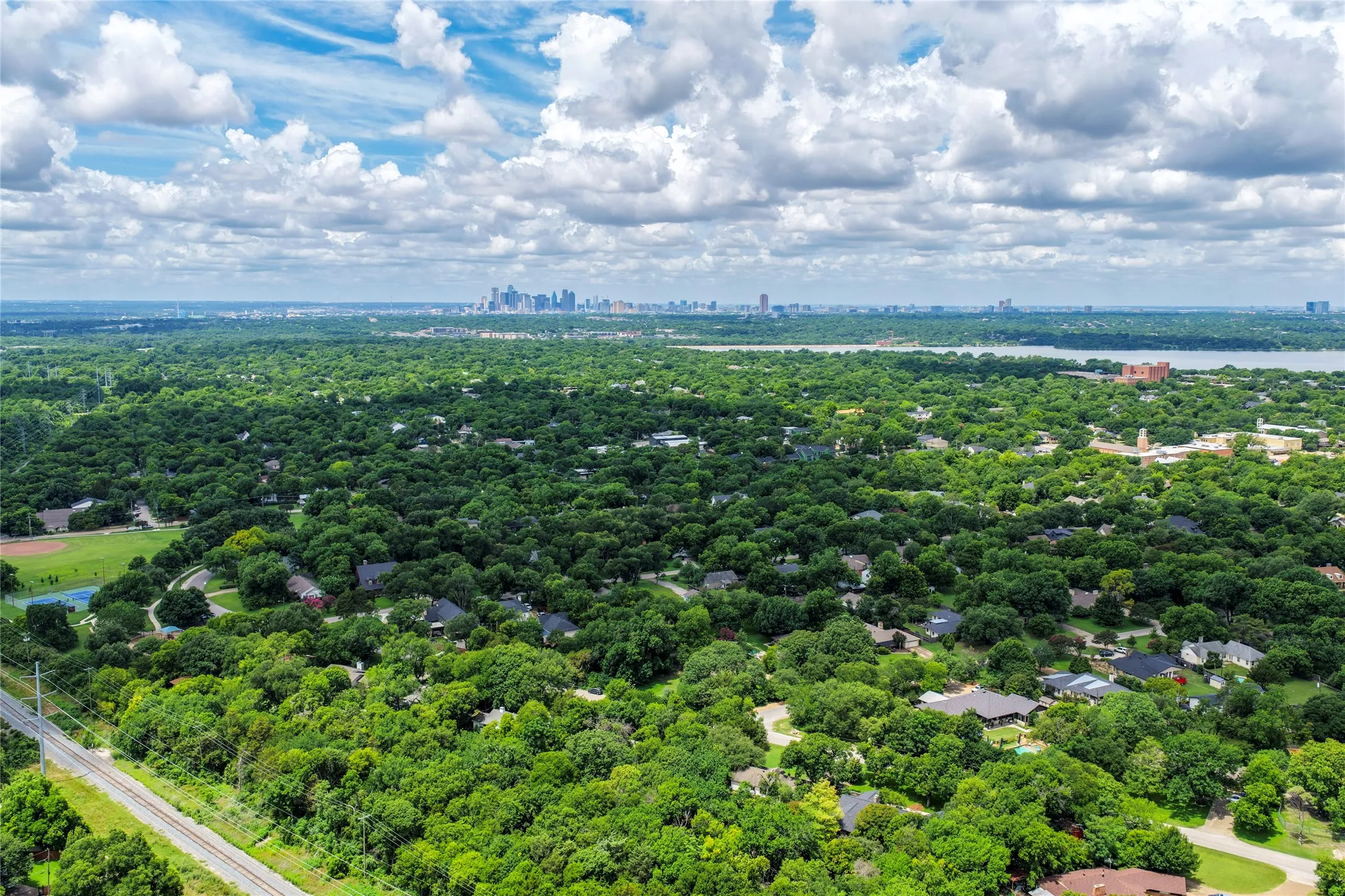 Expansive aerial perspective showcasing a verdant landscape with extensive tree canopy