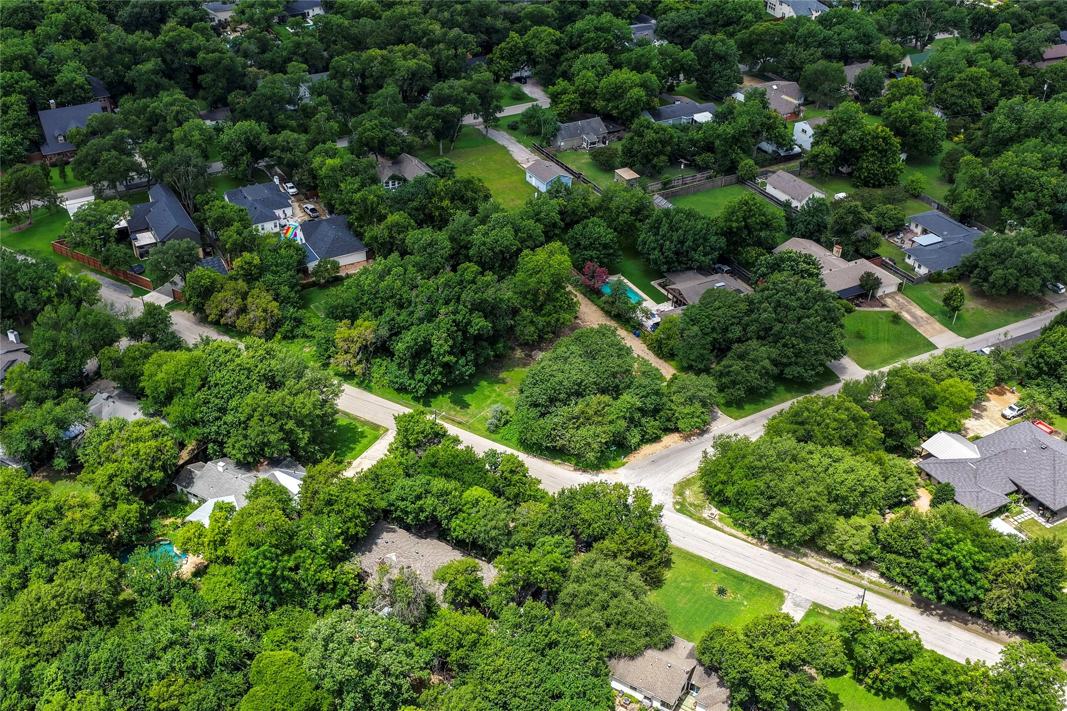 Aerial perspective showcasing residential properties amidst abundant mature trees