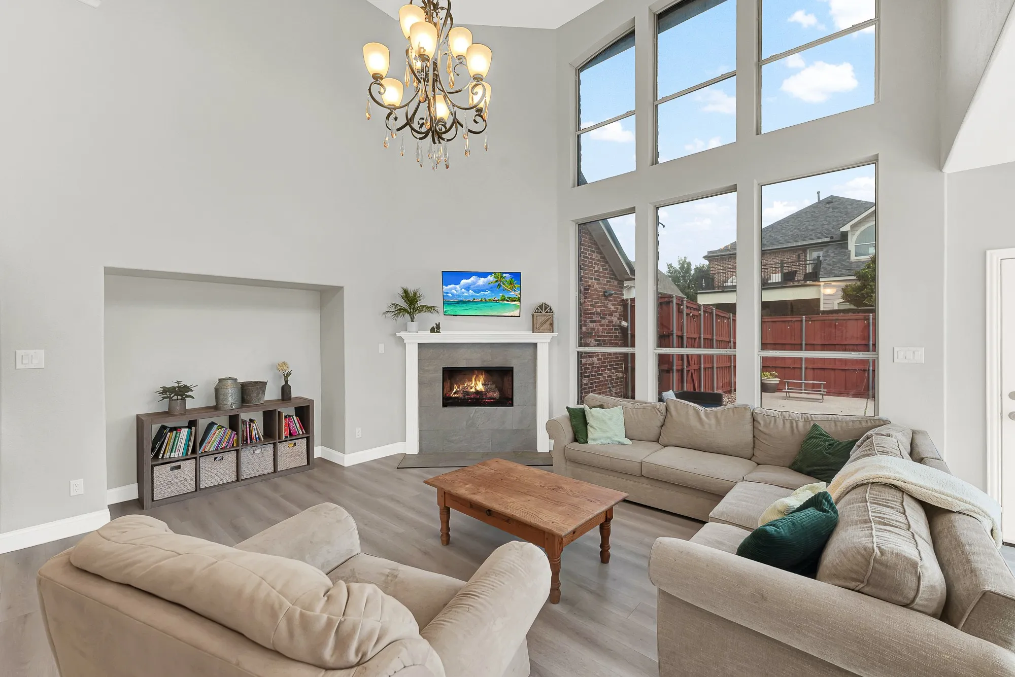 Two-story living area with high ceilings and wood-finish flooring