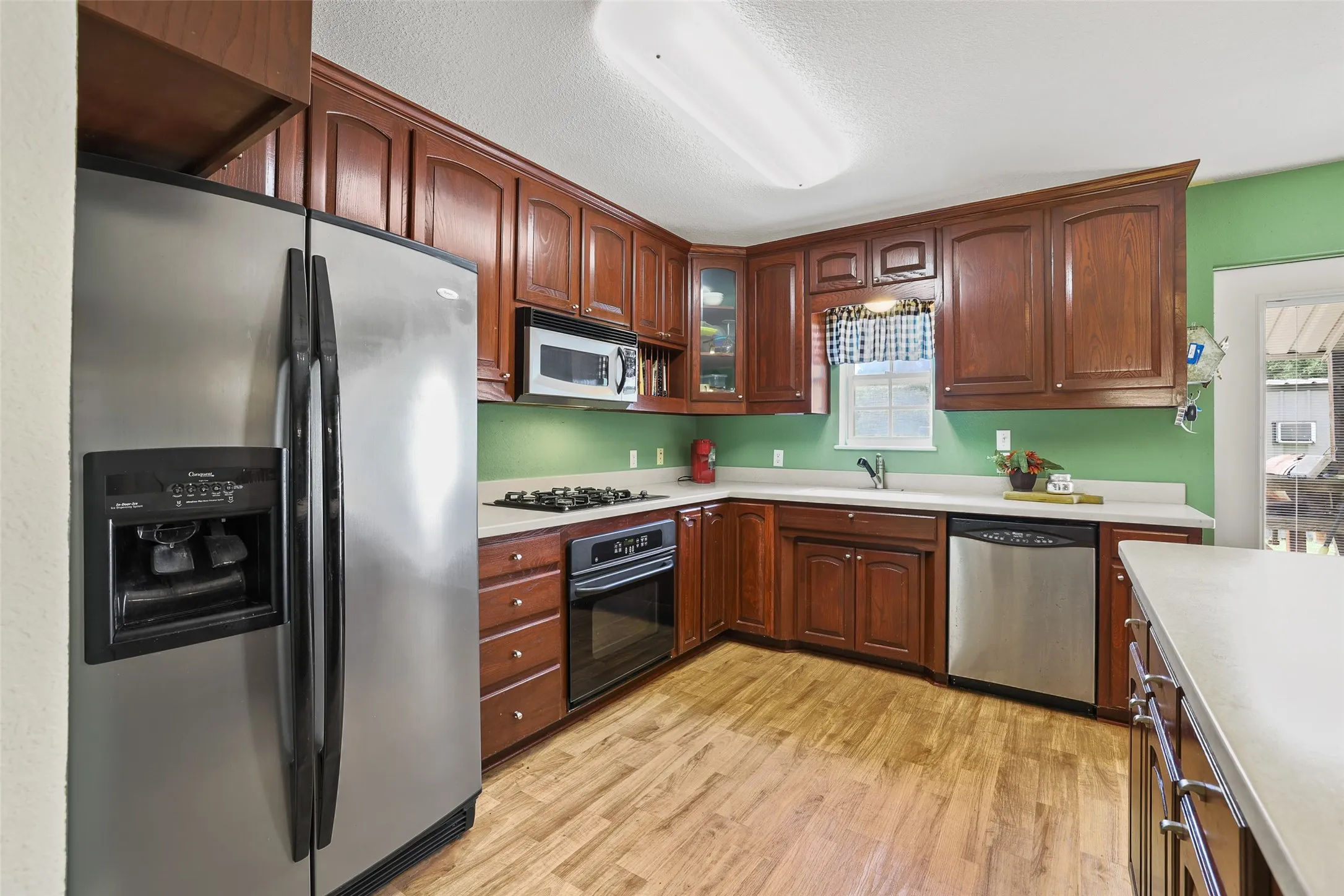 Large kitchen with window overlooking the backyard