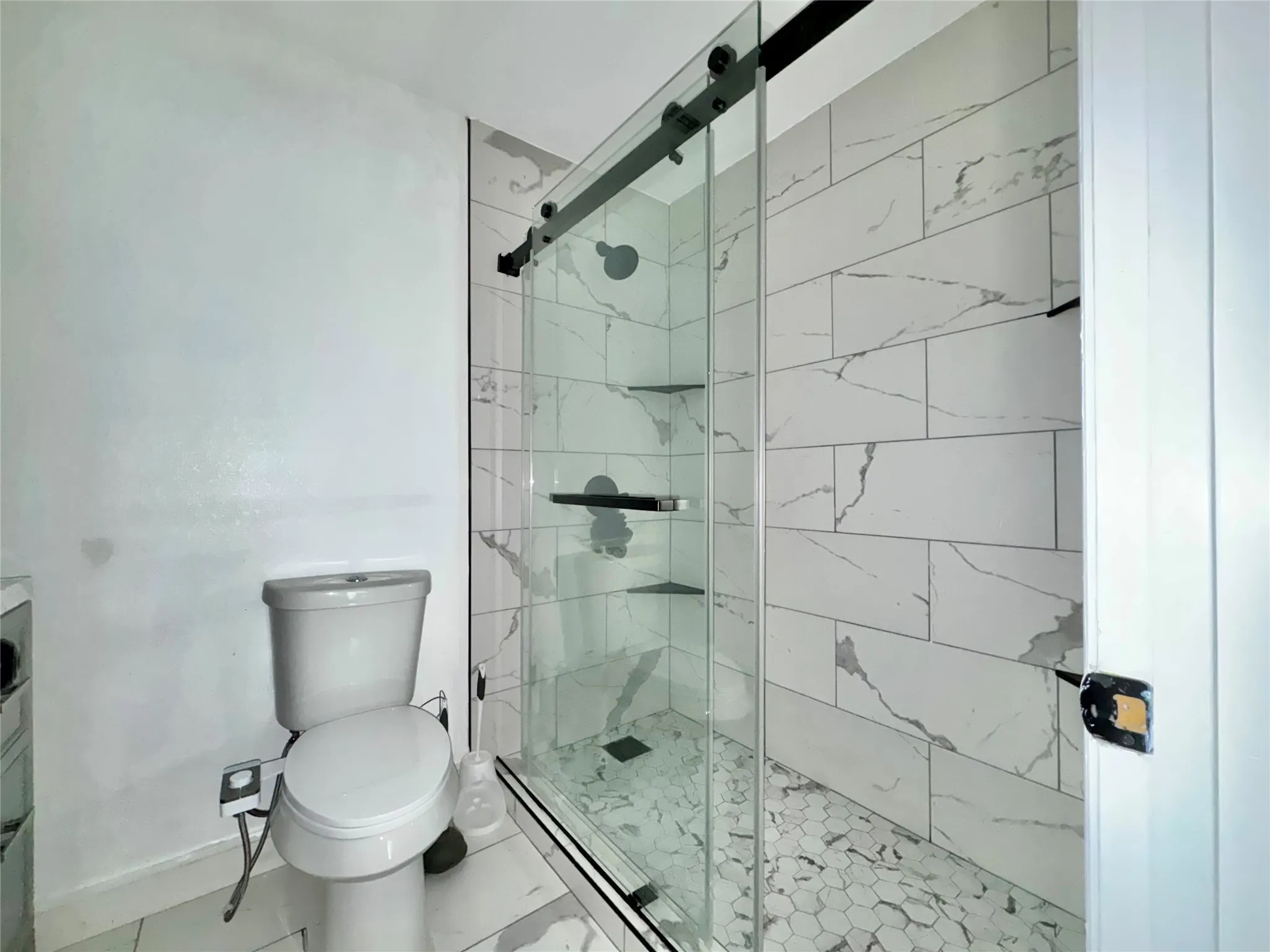En-suite primary bath featuring an updated separate shower with glass sliding doors and a separate vanity.