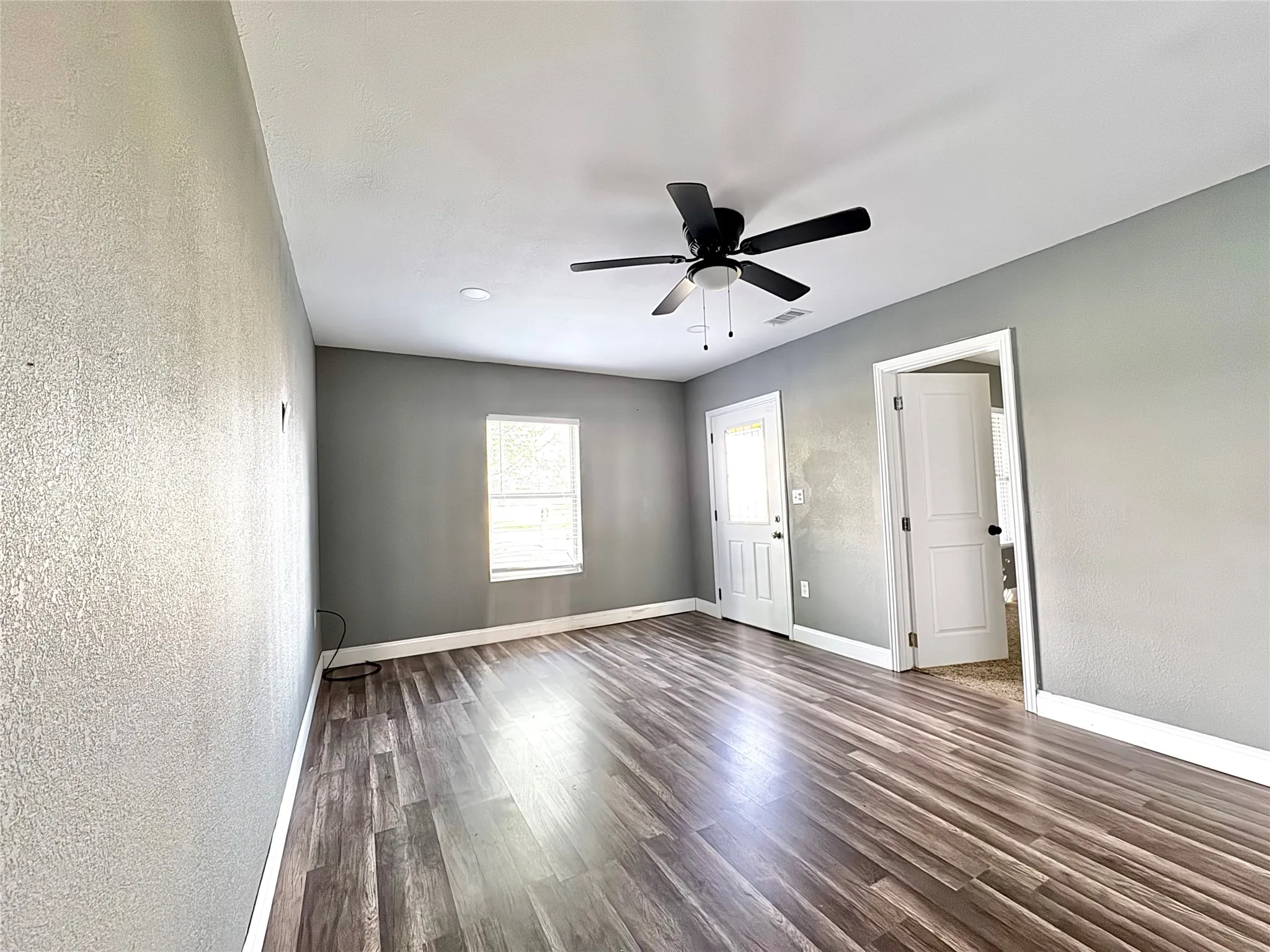 Main living space featuring brand-new paint, luxury vinyl plank floors, and a newly installed HVAC system.
