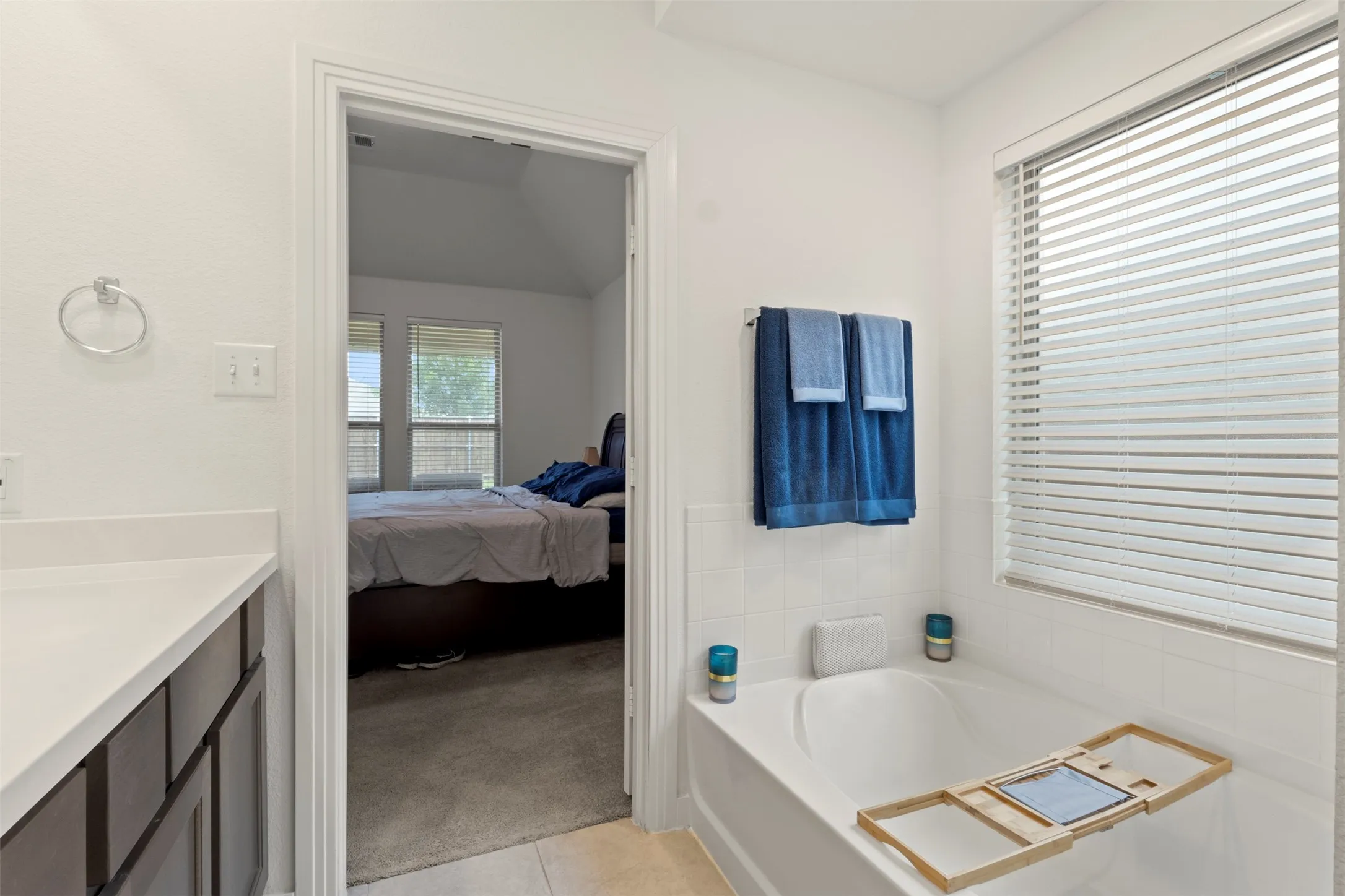 Primary bathroom with dual sink vanity, bath and shower