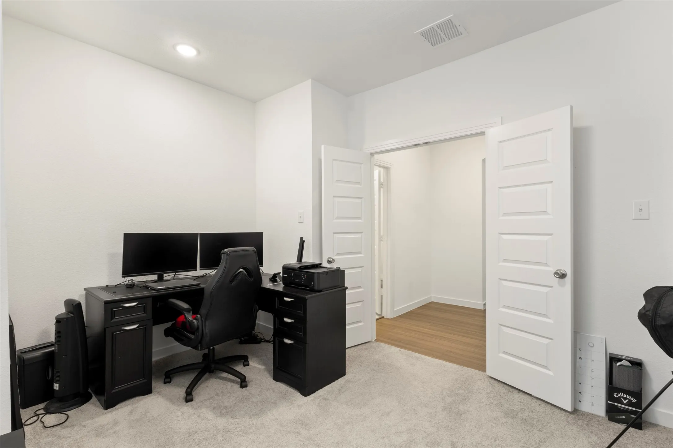 Office area featuring light carpet and recessed lighting